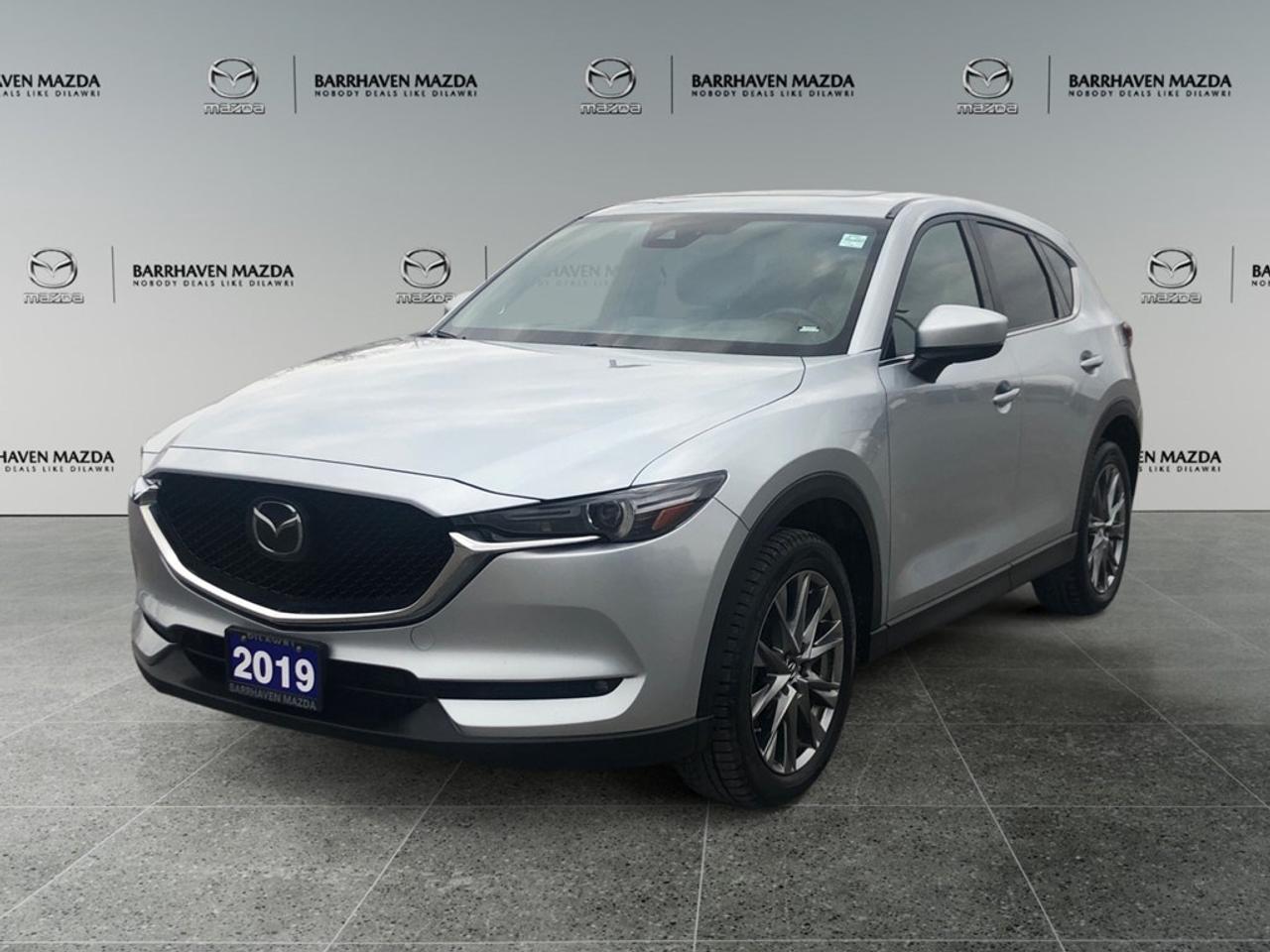 Experience the refined elegance of the 2019 Mazda CX-5 Signature Diesel in stunning Silver with a responsive AWD drivetrain. The automatic transmission ensures a smooth and controlled driving experience, highlighting Mazdas commitment to performance and handling. The sleek exterior design of this SUV is complemented by alloy wheels and a striking silver finish that catches the eye. Step inside to a world of luxury with comfortable leather seats, a sophisticated leather-wrapped steering wheel, and meticulous detailing featuring leatherette door trim. Both the front and rear seats are heated for ultimate comfort, while the front seats also offer a cooling option. Technology takes center stage with a navigation system and heads-up display that keep you connected and informed. The backup camera, lane assist, and adaptive cruise control enhance safety and driver assistance. Smart device integration ensures seamless connectivity, paired with Bluetooth capability and a premium satellite radio for entertainment on the go. This vehicle is perfect for discerning drivers who value luxury, technology, and performance in equal measure. Contact us today to schedule a test drive and explore the unmatched quality of the 2019 Mazda CX-5 Signature Diesel. Our sales team is ready to assist you with any questions and help you make this exceptional SUV your own.