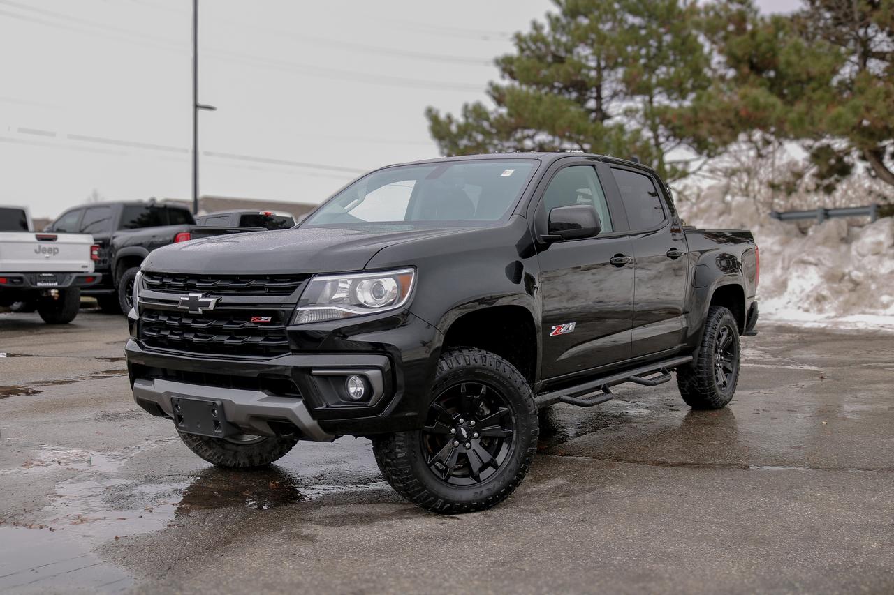 NAVIGATION, BACKUP CAMERA, BLUETOOTH, HEATED SEATS, REMOTE START, BOSE AUDIO AND MORE!!!

Step inside our Accident-Free 2021 Chevrolet Colorado Z71 Crew Cab 4X4 that is eager for adventure and reporting for duty in Black!  This trail-friendly Four Wheel Drive truck features an off-road suspension, an automatic locking rear differential, and hill-descent control for confidence on tough terrain. Our Colorado makes its mark with a bold black Bowtie emblem on the grille plus projector-beam headlamps, fog lamps, black alloy wheels, a corner step rear bumper, side steps, and a remote-locking EZ-Lift and Lower tailgate.

Our Z71 cabin keeps you comfortable on your rugged journeys with cloth/leatherette heated front seats, rear under-seat storage, a leather heated steering wheel, cruise control, automatic climate control, and high-tech convenience from an 8-inch touchscreen, WiFi compatibility, Android Auto&reg;, Apple CarPlay&reg;, Bluetooth&reg;, and a six-speaker audio system. Youre in command with features like those!

Chevrolet inspires you to explore confidence thanks to a rearview camera, ABS, StabiliTrak stability/traction controls, tire-pressure monitoring, and seat-mounted and head-curtain airbags. With all that and more, our Colorado Z71 is always ready to come through in the clutch! Save this Page and Call for Availability. We Know You Will Enjoy Your Test Drive Towards Ownership! 

Bustard Chrysler prides ourselves on our expansive used car inventory. We have over 100 pre-owned units in stock of all makes and models, with the largest selection of pre-owned Chrysler, Dodge, Jeep, and RAM products in the tri-cities. Our used inventory is hand-selected and we only sell the best vehicles, for a fair price. We use a market-based pricing system so that you can be confident youre getting the best deal. With over 25 years of financing experience, our team is committed to getting you approved - whether you have good credit, bad credit, or no credit! We strive to be 100% transparent, and we stand behind the products we sell. For your peace of mind, we offer a 3 day/250 km exchange as well as a 30-day limited warranty on all certified used vehicles.