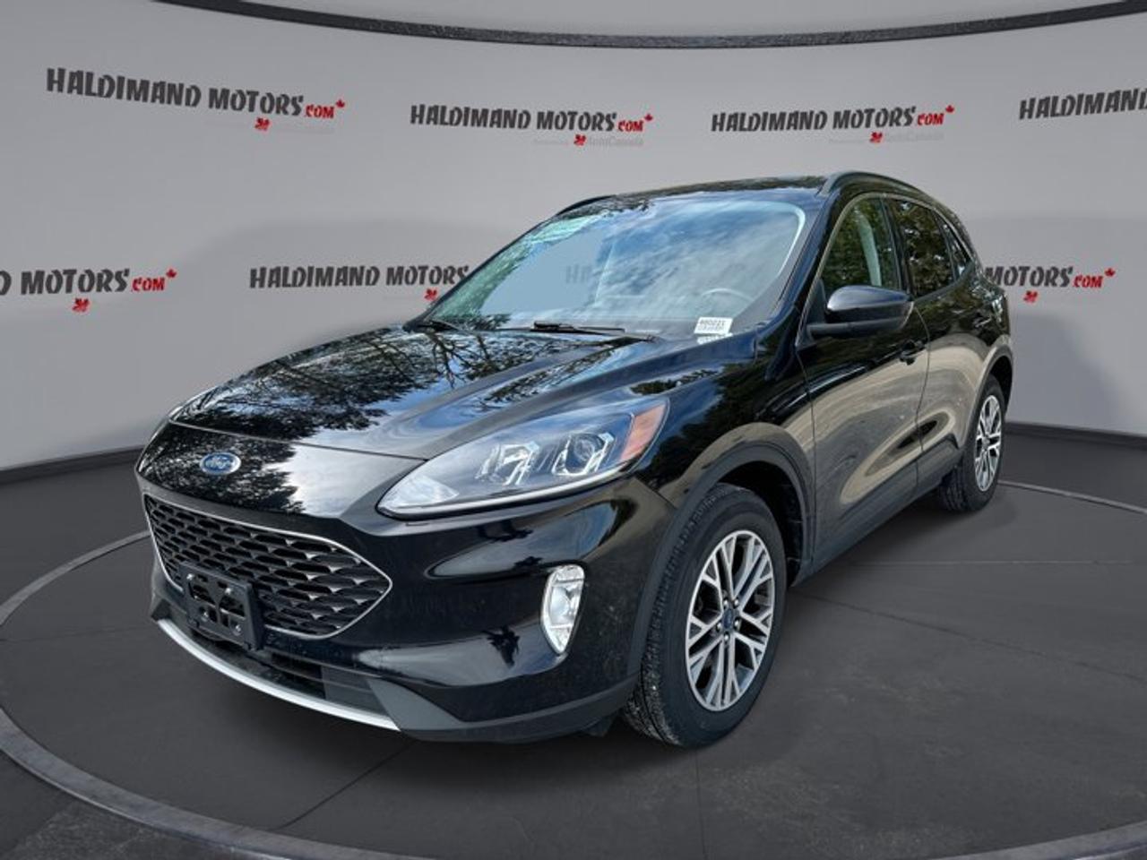 The 2021 Ford Escape SEL AWD is a smart fit for daily life in Cayuga. This used SUV blends confident all-wheel drive, a fuel-friendly 1.5-litre gas engine, and a smooth 8-speed automatic transmission. With 37,757 km, black exterior paint, and a black interior, it delivers a clean, modern look.<br /><br />This 2021 Ford Escape SEL AWD also brings the comfort and convenience many drivers want most. Leather seats, heated front seats, a heated steering wheel, remote starter, navigation, and a power liftgate make every trip easier. Four doors and a practical cabin layout help this SUV handle commuting, errands, and weekend travel with ease.<br /><br />FEATURES OF THE Escape SEL AWD | Leather Seats<br /><br />   1.5-litre gas engine balances power efficiently<br />   All-wheel drive adds year-round confidence<br />   8-speed automatic shifts smoothly and quietly<br />   Power liftgate adds everyday loading ease<br /><br />ADVANCED SAFETY FEATURES<br /><br />   Backup camera helps with tight parking<br />   Lane departure warning adds driving support<br />   Blind spot monitor boosts lane awareness<br />   Side and head airbags enhance protection<br /><br />PERFORMANCE AND EFFICIENCY<br /><br />   1.5-litre engine delivers solid everyday response<br />   Automatic 8-speed transmission supports smooth acceleration<br />   All-wheel drive improves traction on roads<br />   Stability control helps keep handling composed<br /><br />COMFORT AND CONVENIENCE<br /><br />   Heated front seats add winter comfort<br />   Heated steering wheel feels great cold<br />   Dual-zone climate control keeps peace onboard<br />   Remote starter adds convenience every season<br /><br />TECHNONOLGY AND CONNECTIVITY<br /><br />   Apple CarPlay connects favourite apps easily<br />   Android Auto keeps smartphone access simple<br />   Navigation system guides trips with clarity<br />   Bluetooth integration supports hands-free communication<br /><br />CARGO SPACE<br /><br />   Power liftgate helps with busy loading<br />   Rear trunk access makes cargo simple<br />   Four-door layout improves passenger entry ease<br />   Spare tire adds roadside peace nearby<br /><br />AWARDS & RECOGNITIONS<br /><br />   Top Safety Pick, Insurance Institute for Highway Safety, 2021<br /><br />WHAT OTHER OWNERS LIKE<br /><br />   Comfortable ride quality for daily driving<br />   User-friendly infotainment with phone integration<br />   Flexible cargo area for active lifestyles<br />   Confident all-wheel drive in bad weather<br /><br />The 2021 Ford Escape SEL AWD stands out with useful features that make every drive more enjoyable. Cruise control, power steering, power windows, heated mirrors, electric mirrors, automatic headlights, fog lights, tinted windows, and push button start all work together to create a simple and rewarding ownership experience.<br /><br />Inside, this 2021 Ford Escape SEL AWD feels thoughtfully equipped for real Canadian driving. The driver benefits from a power seat with lumbar support, steering wheel audio controls, an adjustable steering wheel, front air conditioning, automatic climate control, and illuminated vanity mirrors. Ambient lighting adds a refined touch after dark.<br /><br />This 2021 Ford Escape SEL AWD also supports peace of mind with anti-lock braking, stability control, tire pressure monitoring, child safety locks, automatic door locks, a passenger airbag sensor, and rear window defroster. A rear spoiler and rear tow hook complete the look with added utility and style.<br /><br />For entertainment and convenience, this 2021 Ford Escape SEL AWD includes satellite radio, WiFi hotspot capability, and remote trunk release. It is a well-rounded used SUV that offers comfort, traction, modern tech, and practical versatility in one attractive package from Haldimand Motors Ltd.<br /><br />This 2021 Ford Escape SEL AWD | Leather Seatss VIN is: 1FMCU9H68MUA73089.<br /><br />WHY CHOOSE US? <br /><br />Honest & Transparent Buying Experience: Weve been a trusted name in business since 1984.<br /><br />STRAIGHTFORWARD PRICING:<br />Our Advertised Price Includes:<br />>>Safety Certification (No separate fee!)<br />>>30-Day 100% Mechanical Warranty<br />>>FREE Carfax History Report.<br />>>No upcharge for paying cash.<br />(Prices Exclude HST and Licensing Fees only.)<br /><br />>>Browse 300+ vehicles all in ONE LOCATION<br /><br />EASY FINANCING: Great rates & open loans<br /><br />WE BUY CARS: Get Top Dollar for your trade-in, or sell us your vehicle for CASH! Even if you dont buy from us!<br /><br />STOP BY TODAY<br />Treat yourself - stop by Haldimand Motors Ltd. located at 42 Talbot St E, Cayuga, ON N0A 1E0 to make this car yours today!<br /><br />https://www.haldimandmotors.com/used/stock-460221.html
