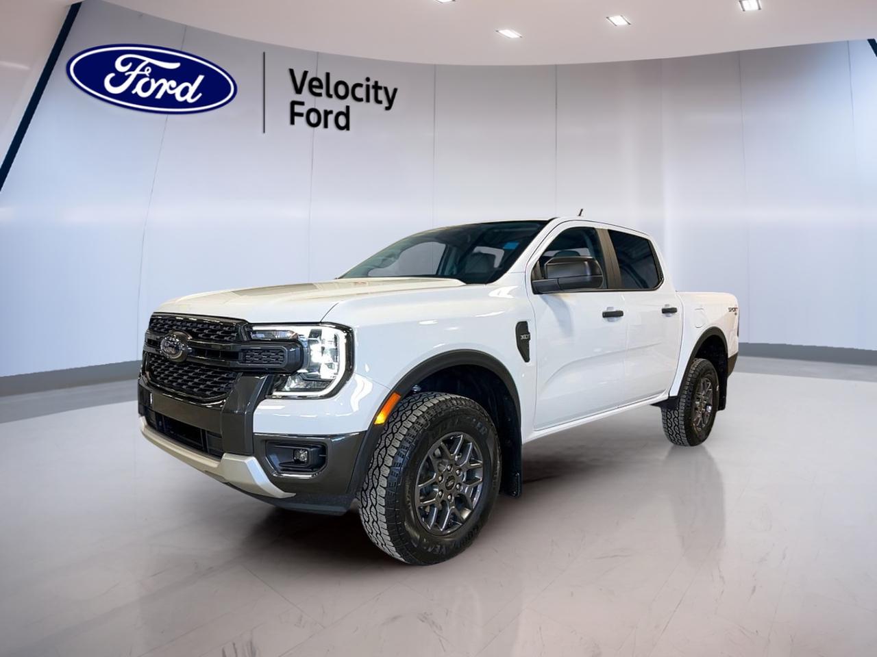 Built for work, play, and daily life, this brand new 2026 Ford Ranger XLT 4WD SuperCrew 5 Box brings smart capability to every drive in Moose Jaw. Its White exterior and Tan interior give it a clean, ready-for-anything look. With four doors, automatic transmission, and a 2.3-litre unleaded engine, this midsize truck delivers the confidence and flexibility many Canadian drivers want.

The 2026 Ford Ranger XLT 4WD SuperCrew 5 Box is well equipped with the features that matter most. You get practical safety systems, useful truck hardware, and easy cabin technology. From remote start to navigation, this new pickup is ready for highway travel, jobsite use, and weekend towing with solid everyday comfort.

FEATURES OF THE Ranger XLT 4WD SuperCrew 5 Box
»» White exterior with Tan interior
»» Four-door SuperCrew cab for easy access
»» Automatic transmission with dual shift mode
»» 2.3-litre unleaded engine with 4WD

TRUCK FEATURES
»» Tows up to 1,588 kg confidently
»» Rear tow hook adds utility
»» Off-road tires support rough surfaces
»» Four-wheel drive boosts traction year-round

ADVANCED SAFETY FEATURES
»» Anti-Lock Braking System helps controlled stops
»» Stability Control supports secure handling
»» Backup camera aids reversing visibility
»» Blind Spot Monitor adds lane awareness

PERFORMANCE AND EFFICIENCY
»» 2.3-litre engine balances power and efficiency
»» Automatic transmission delivers smooth shifting
»» Dual shift mode adds driver control
»» Four-wheel drive handles changing road conditions

COMFORT AND CONVENIENCE
»» Remote starter adds cold-weather convenience
»» Front air conditioning keeps cabin comfortable
»» Power windows simplify daily use
»» Driver lumbar support improves comfort

TECHNONOLGY AND CONNECTIVITY
»» Navigation system helps guide every trip
»» Bluetooth integration supports hands-free calling
»» WiFi hotspot keeps devices connected
»» Steering wheel audio controls add ease

CARGO SPACE
»» Pickup box supports gear and supplies
»» SuperCrew cabin adds secure interior storage
»» Spare tire supports travel confidence
»» Four doors improve loading flexibility

WHAT OTHER OWNERS LIKE
»» Useful towing ability for everyday tasks
»» Easy-to-use cabin technology and controls
»» Comfortable ride with strong visibility
»» Confident four-wheel drive capability year-round

This brand new truck also includes cruise control, power steering, electric mirrors, tinted windows, satellite radio, automatic headlights, fog lights, LED headlamps, tire pressure monitoring, rear window defroster, automatic door locks, and an auto-dimming rearview mirror. Important protection features include driver and passenger airbags, side impact airbags, head side airbags, child safety locks, lane departure warning, and a passenger airbag sensor.

At Velocity Ford in Moose Jaw, this new Ranger is a smart choice for drivers who need midsize truck versatility without giving up comfort or modern convenience. It is ready for commuting, hauling, towing, and changing prairie weather, all with the proven utility that makes a pickup such a practical fit for life in Saskatchewan.

This 2026 Ford Ranger XLT 4WD SuperCrew 5 Boxs VIN is: 1FTER4HH6TLE09586.