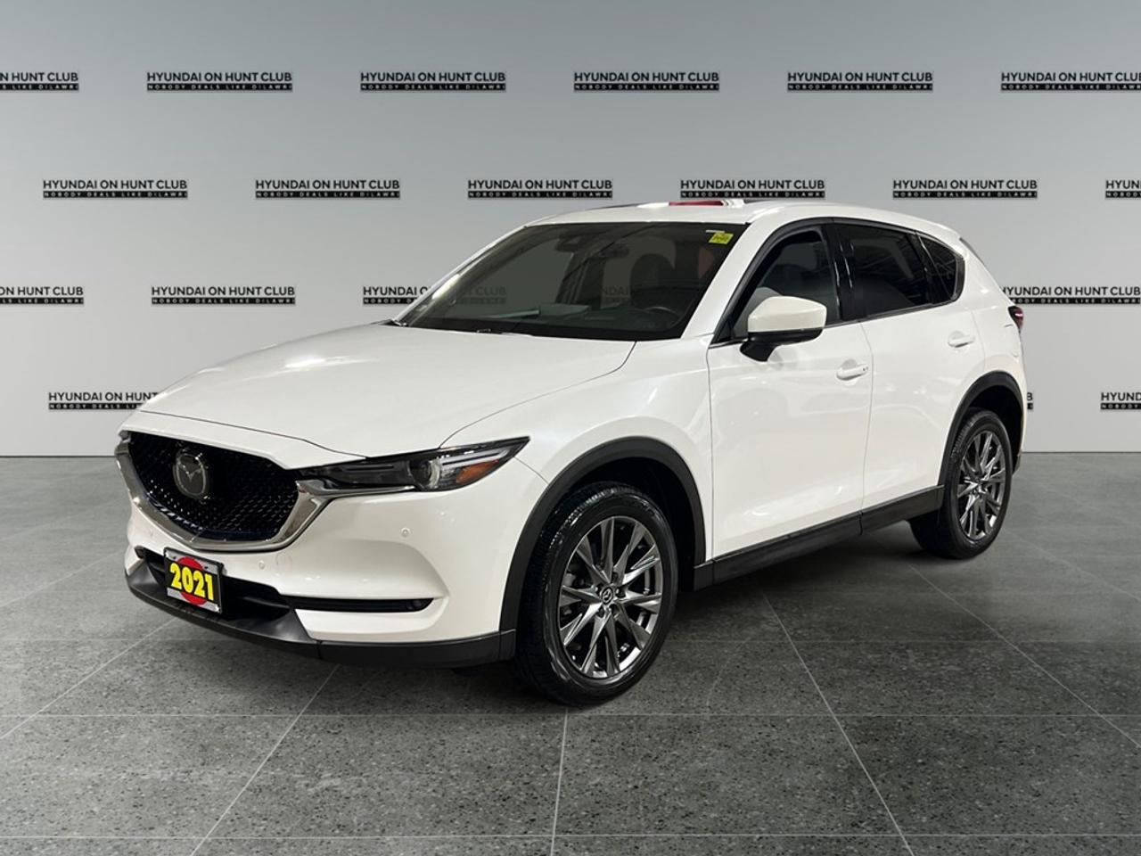 * $32,999 Cash * $30,888Finance The 2021 Mazda CX-5 Signature AWD is here to elevate your driving experience with its stunning craftsmanship. Presented in a captivating color that complements its athletic stance, this all-wheel-drive SUV is designed for those who crave performance and precision. The exterior of the CX-5 Signature exudes sophistication with its distinctive alloy wheels and elegant sunroof/moonroof, while its meticulously designed interior beckons with luxurious features. Enjoy the upscale comfort of leather seatsboth heated and cooled for year-round comfortalongside advanced leatherette door trim and a refined leather gear shifter. This SUV comes packed with the latest technology to keep you connected and safe on the road. The intuitive infotainment system with smart device integration and a navigation system ensures that youre always in command, while the backup camera and parking sensors make maneuvers effortless. Safety is further enhanced with a suite of driver assistance features including lane assist, adaptive cruise control, and a comprehensive heads-up display. The Mazda CX-5 Signature AWD is the perfect choice for discerning drivers seeking a harmonious blend of luxury and practicality. Dont miss the opportunity to experience this premium SUV. Contact us today for more information and to schedule a test drive! **ADVERTISED PRICE IS FOR FINANCE DEALS ONLY, CASH PRICE MAY BE SUBJECT TO INCREASE. SEE DEALER FOR DETAILS**