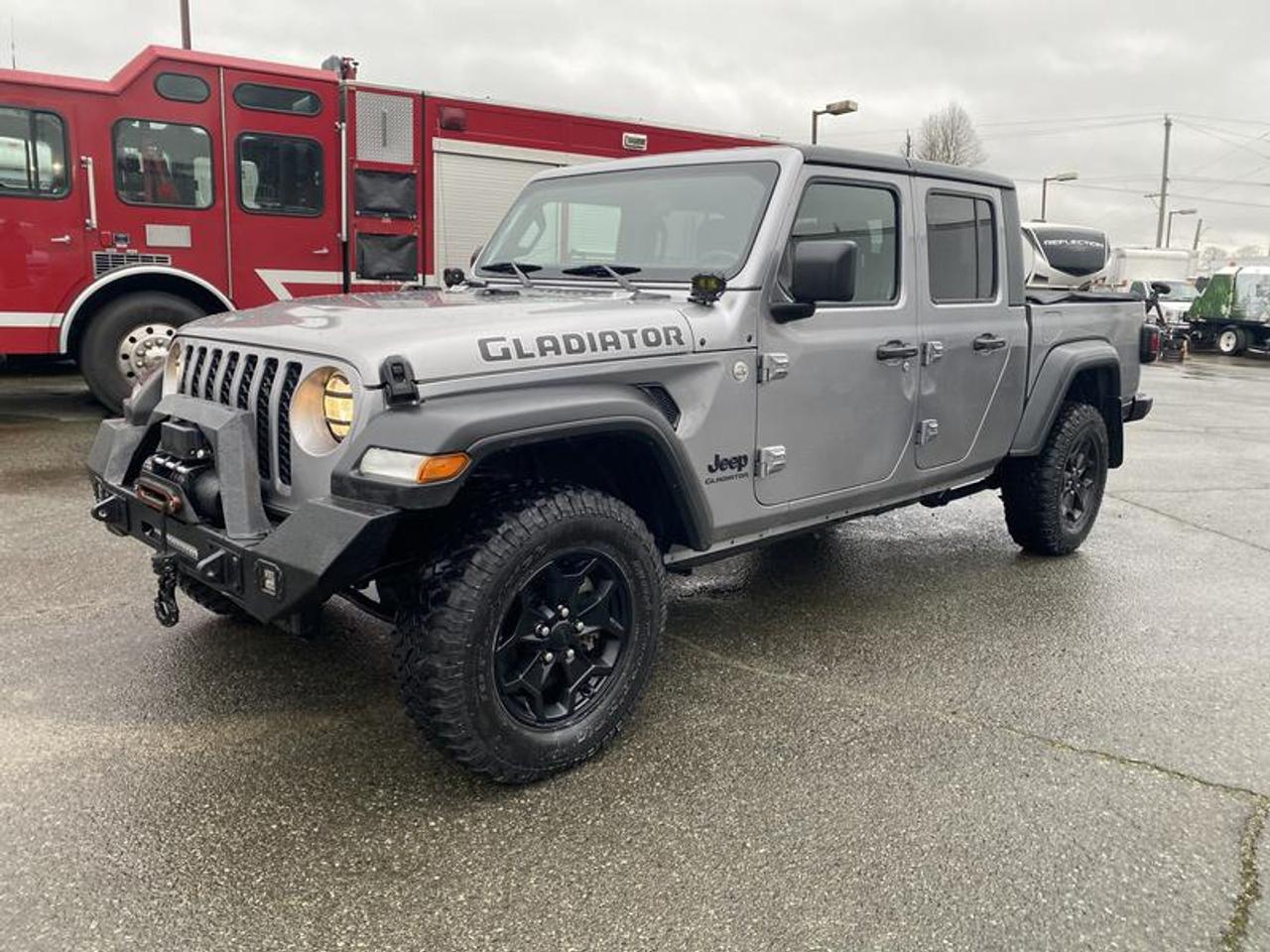 2020 Jeep Gladiator Sport, 3.6L, 6 cylinder, 4 door, automatic , 4WD, 4-Wheel ABS, cruise control, gray exterior, black interior, cloth. This Listing has Rebuilt Status  $22,560.00 plus $375 processing fee, $22,935.00 total payment obligation before taxes.  Listing report, warranty, contract commitment cancellation fee, financing available on approved credit (some limitations and exceptions may apply). All above specifications and information is considered to be accurate but is not guaranteed and no opinion or advice is given as to whether this item should be purchased. We do not allow test drives due to theft, fraud, acts of vandalism and undetectable impaired driving. Instead we provide the following benefits: Complimentary Warranty (with options to extend), Limited Money Back Satisfaction Guarantee on Fully Completed Contracts, Contract Commitment Cancellation, and an Open-Ended Sell-Back Option. Ask seller for details or call 604-522-REPO(7376) to confirm listing availability.
