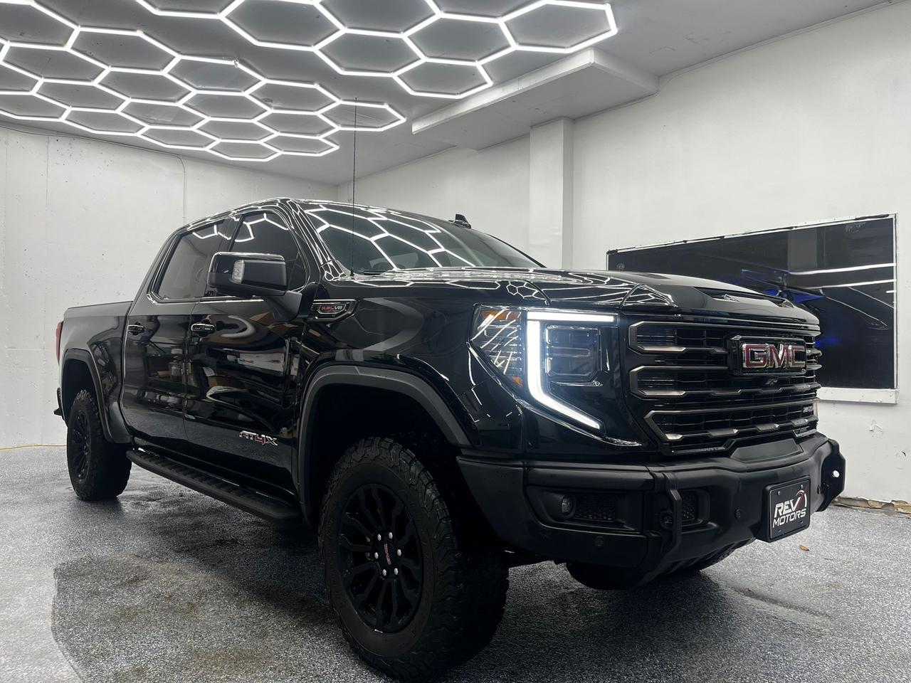 2023 GMC Sierra 1500 AT4X | Keyless Entry | Bose Sound System | Heated & Ventilated Seats<br/> <br/> Black Exterior | Black Leather Interior | AT4X Trim | 4-Door Full-Size Pickup Truck | Off-Road Performance Styling | 18-Inch Gloss Black Alloy Wheels | Multimatic DSSV Dampers | Off-Road Suspension | Skid Plates | Keyless Entry with Push Button Start | Premium Leather Upholstery | Navigation System | Bose® Premium Audio | Dual-Zone Climate Control | Heated & Ventilated Front Seats | 10-Speed Automatic Transmission | 4WD with Terrain Mode Rugged Capability and More <br/> <br/> <br/> Key Features: <br/> <br/> <br/> Bold Presence: <br/> The Black exterior paired with a Black leather interior creates a commanding and aggressive look. With its muscular stance, off-road accents, and signature GMC grille, the Sierra AT4X projects strength and capability. <br/> <br/> <br/> Engineered to Perform: <br/> Powered by a 6.2L V8 engine delivering 420 horsepower and 460 lb-ft of torque, the AT4X is built for both power and precision. Multimatic DSSV dampers, off-road suspension, and 4WD with Terrain Mode ensure confidence across rugged trails and demanding conditions. <br/> <br/> <br/> Luxury Meets Utility: <br/> Inside, the cabin is finished with premium leather seating and refined detailing. Heated and ventilated front seats, dual-zone climate control, and advanced ergonomics provide comfort, while the spacious interior balances rugged utility with upscale refinement. <br/> <br/> <br/> Smart Connectivity: <br/> Equipped with GMC’s latest infotainment system, navigation, and Bose® premium audio, the Sierra AT4X offers intuitive control and immersive sound. Smartphone integration ensures seamless connectivity for work or adventure. <br/> <br/> <br/> Confidence and Control: <br/> Advanced driver-assistance features include Forward Collision Alert, Lane Keeping Assist, Blind Spot Monitoring, and Adaptive Cruise Control. Combined with off-road hardware and performance brakes, the AT4X delivers stability, safety, and capability in every environment. <br/> <br/> <br/> The 2023 GMC Sierra 1500 AT4X is a premium off-road pickup that blends rugged engineering with refined luxury. With its powerful V8, advanced suspension, and upscale interior, it delivers a driving experience that is equally thrilling on the trail and comfortable on the highway. <br/> <br/> <br/> This Vehicle Has Travelled 117,126 Kms. <br/> <br/> <br/> *** NO additional fees except for taxes and licensing! *** <br/> <br/> <br/> *** 100-point inspection on all our vehicles & always detailed inside and out *** <br/> <br/> <br/> RevMotors is at your service to ensure you find the right car for YOU. Even if we do not have it in our inventory, we are more than happy to find you the vehicle that you are looking for. Give us a call at 613-791-3000 or visit us online at www.revmotors.ca <br/> <br/> <br/> Ça nous donnera du plaisir de vous servir en Français aussi! <br/> <br/> <br/> CERTIFICATION * All our vehicles are sold Certified for the province of Ontario (Quebec Safety Available, additional charges may apply) <br/> FINANCING AVAILABLE * RevMotors offers competitive finance rates through many of the major banks. Should you feel like youve had credit issues in the past, we have various financing solutions to get you on the road. We accept No Credit - New Credit - Bad Credit - Bankruptcy - Students and more!! <br/> EXTENDED WARRANTY * For your peace of mind, if one of our used vehicles is no longer covered under the manufacturer’s warranty, RevMotors will provide you with a 6 month / 6000KMS Limited Powertrain Warranty. You always have the options to upgrade to more comprehensive coverage as well. Well be more than happy to review the options and chose the coverage thats right for you! <br/> TRADES * Do you have a Trade-in? We offer competitive trade in offers for your current vehicle! <br/> SHIPPING * We can ship anywhere across Canada. Give us a call for a quote and we will be happy to help! <br/> <br/> <br/> Buy with confidence knowing that we always have your best interests in mind! <br/>