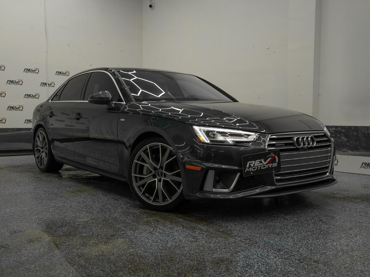 2019 Audi A4 Prestige | Bang & Olufsen Sound | Audi Virtual Coskpit | No Accidents | AWD<br/> <br/> Manhattan Grey Metallic Exterior | Black / Titanium Grey Interior | 4 Cyl | AWD | Audi Drive Select | Audi 19 5 Spoke Wheels | Audi Pre-Sense City | Lane Keep Assist | Lane Change Assistant | LED Headlamps | LED Rear Combination Lamps with Dynamic Turn Signal | Adaptive Cruise Control | 3-Zone Climate Control System | Audi Virtual Cockpit | 360 Degree Camera | Driver Assistance Package | Traffic Sign Recognition | Technology Package | S-Line Sport Package | Prestige Package | Navigation Package | Comfort Package | Parking Assistance Package | Bang & Olufsen® Premium Sound System And much more <br/> <br/> <br/> The 2019 Audi A4 Prestige delivers a sophisticated blend of refined luxury, advanced technology, and dynamic performance. With its sleek Manhattan Grey exterior and Black leather interior, this sedan commands attention and offers an unforgettable driving experience. <br/> <br/> <br/> Key Features: <br/> <br/> <br/> Elegant Design: <br/> Manhattan Grey Metallic finish paired with bold S Line styling, signature Singleframe® grille, and 19-inch sport wheels. LED headlights and clean lines emphasize its modern, athletic character. <br/> <br/> <br/> Performance That Excites: <br/> Powered by a 2.0L turbocharged engine producing 248 hp and paired with Audi’s legendary Quattro® all-wheel drive for superior traction and handling. Audi Drive Select lets you customize your driving experience. <br/> <br/> <br/> Luxury Interior: <br/> Premium black leather seating, heated and ventilated front seats, heated rear seats, and a power sunroof create a first-class cabin designed for comfort and sophistication. <br/> <br/> <br/> Advanced Technology: <br/> Audi Virtual Cockpit with a 12.3-inch digital display, MMI® Navigation Plus, Bluetooth connectivity, Apple CarPlay®, Android Auto™, and Bang & Olufsen® premium audio system for an immersive sound experience. <br/> <br/> <br/> Safety & Assistance: <br/> Lane Assist, Blind Spot Monitoring, Parking Sensors, Rearview Camera, and Adaptive Cruise Control provide confidence and peace of mind on every drive. <br/> <br/> <br/> The 2019 Audi A4 Prestige is the ultimate expression of Audi craftsmanship—combining elegance, innovation, and performance for drivers who demand the best. <br/> <br/> <br/> This vehicle has travelled 128,442 Kms. <br/> <br/> <br/> *** NO additional fees except for taxes and licensing! *** <br/> <br/> <br/> *** 100-point inspection on all our vehicles & always detailed inside and out *** <br/> <br/> <br/> RevMotors is at your service to ensure you find the right car for YOU. Even if we do not have it in our inventory, we are more than happy to find you the vehicle that you are looking for. Give us a call at 613-791-3000 or visit us online at www.revmotors.ca <br/> <br/> <br/> Ça nous donnera du plaisir de vous servir en Français aussi! <br/> <br/> <br/> CERTIFICATION * All our vehicles are sold Certified for the province of Ontario (Quebec Safety Available, additional charges may apply) <br/> FINANCING AVAILABLE * RevMotors offers competitive finance rates through many of the major banks. Should you feel like youve had credit issues in the past, we have various financing solutions to get you on the road. We accept No Credit - New Credit - Bad Credit - Bankruptcy - Students and more!! <br/> EXTENDED WARRANTY * For your peace of mind, if one of our used vehicles is no longer covered under the manufacturer’s warranty, RevMotors will provide you with a 6 month / 6000KMS Limited Powertrain Warranty. You always have the options to upgrade to more comprehensive coverage as well. Well be more than happy to review the options and chose the coverage thats right for you! <br/> TRADES * Do you have a Trade-in? We offer competitive trade in offers for your current vehicle! <br/> SHIPPING * We can ship anywhere across Canada. Give us a call for a quote and we will be happy to help! <br/> <br/> <br/> Buy with confidence knowing that we always have your best interests in mind! <br/>