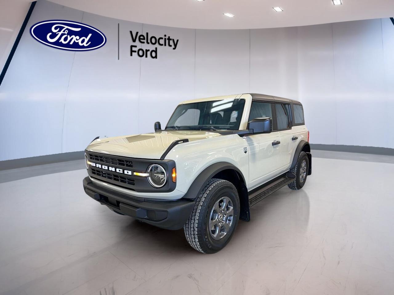 Fresh, capable, and ready for every season, this brand new 2026 Ford Bronco Big Bend at Velocity Ford in Moose Jaw brings real SUV confidence to your daily drive and weekend plans. Finished in Desert Sand with a Grey interior, it pairs classic Bronco attitude with a 2.3-litre EcoBoost I-4 engine, a 10-speed automatic transmission, and an engine block heater for cold Saskatchewan mornings.

The 2026 Ford Bronco Big Bend is built for drivers who want practical utility with authentic off-road roots. Its upright design, easy visibility, and durable engineering make it a smart fit for city streets, highways, and rougher routes beyond town. This new Bronco Big Bend delivers proven turbocharged power and the everyday ease many Canadian drivers want.

FEATURES OF THE Bronco Big Bend
»» Brand new SUV with rugged Bronco character
»» Desert Sand exterior with Grey interior
»» 2.3-litre EcoBoost I-4 engine included
»» Engine block heater for cold starts

ADVANCED SAFETY FEATURES
»» Strong SUV structure for added confidence
»» High driving position improves outward visibility
»» Four-wheel disc braking supports controlled stops
»» Traction-focused design suits varied road conditions

PERFORMANCE AND EFFICIENCY
»» 2.3-litre EcoBoost engine delivers turbocharged response
»» 10-speed automatic supports smooth shifting
»» Balanced power for highway and city
»» Engine block heater helps winter readiness

COMFORT AND CONVENIENCE
»» Spacious cabin supports daily driving comfort
»» Upright layout allows easy entry
»» Practical controls are simple to reach
»» Versatile SUV design suits active lifestyles

TECHNONOLGY AND CONNECTIVITY
»» Driver-focused layout keeps information in view
»» Modern cabin design feels clear and functional
»» Easy-to-use controls support everyday operation
»» Well-planned dash enhances driving convenience

CARGO SPACE
»» Rear cargo area supports daily gear
»» Flexible interior suits errands and trips
»» SUV shape helps load larger items
»» Useful storage supports busy routines

WHAT OTHER OWNERS LIKE
»» Confident turbo power for varied driving
»» Comfortable ride height and visibility
»» Practical cargo space for everyday use
»» Rugged Bronco design and versatility

This 2026 Ford Bronco Big Bends VIN is: 1FMDE7BH0TLA62477.