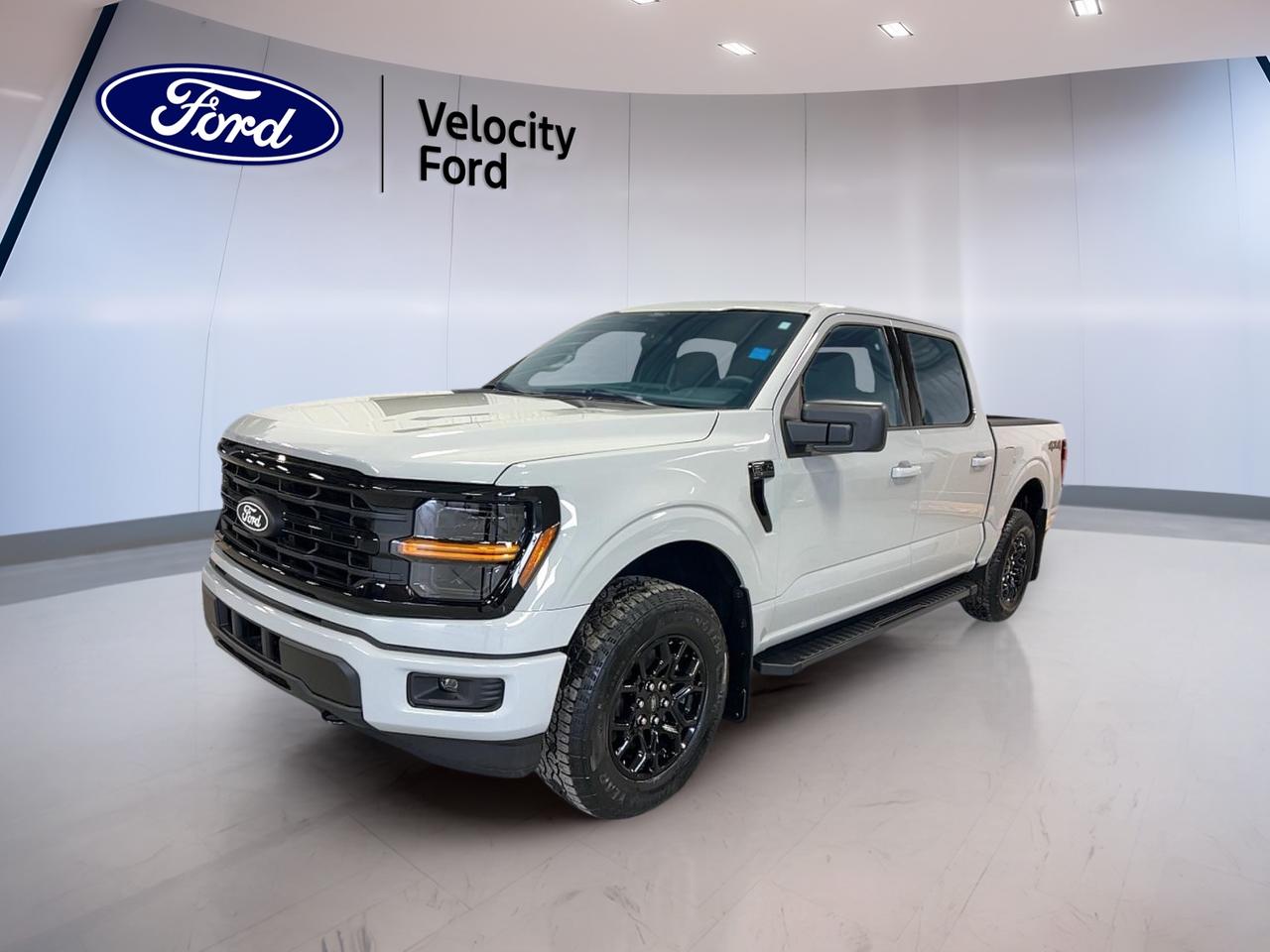 The brand new 2026 Ford F-150 XLT 4WD SuperCrew 5.5 Box is built to handle hard work and daily life with ease. Offered by Velocity Ford in Moose Jaw, this white full-size truck pairs a black interior with a practical four-door cabin, automatic transmission, and a 2.7-litre unleaded engine.

This new Ford pickup delivers the versatility many Canadian drivers want. Its SuperCrew cab adds easy rear-seat access, while four-wheel drive supports confident travel on rough roads, job sites, and changing prairie weather. A 5.5-foot box helps balance cargo utility with easy parking and everyday manoeuvrability.

FEATURES OF THE F-150 XLT 4WD SuperCrew 5.5 Box
»» SuperCrew cabin adds roomy rear access
»» Four-wheel drive supports year-round traction
»» 5.5-foot box suits daily hauling needs
»» Automatic transmission delivers smooth operation

TRUCK FEATURES
»» Tows up to 4,671 kg confidently
»» Rear tow hook aids truck utility
»» Off-road tires support rougher surfaces
»» Short box helps easier urban parking

ADVANCED SAFETY FEATURES
»» Backup camera helps safer reversing
»» Blind spot monitor boosts lane awareness
»» Lane departure warning adds confidence
»» Side and head airbags enhance protection

PERFORMANCE AND EFFICIENCY
»» 2.7-litre unleaded engine balances power
»» Automatic transmission supports smooth shifting
»» Dual shift mode adds control
»» Four-wheel drive improves traction year-round

COMFORT AND CONVENIENCE
»» Cruise control supports relaxed highway driving
»» Front air conditioning keeps cabin comfortable
»» Power windows add daily convenience
»» Driver lumbar support improves comfort

TECHNONOLGY AND CONNECTIVITY
»» Bluetooth integration supports hands-free calling
»» WiFi hotspot helps keep devices connected
»» Satellite radio expands entertainment choices
»» Steering wheel audio controls simplify use

CARGO SPACE
»» 5.5-foot box handles everyday cargo
»» Rear trunk access aids loading ease
»» Four-door cabin improves passenger flexibility
»» Spare tire supports travel confidence

WHAT OTHER OWNERS LIKE
»» Strong towing for work and play
»» Comfortable cabin for everyday driving
»» User-friendly tech and connectivity features
»» Confident four-wheel drive capability

Finished in white with a black interior, this 2026 Ford F-150 XLT 4WD SuperCrew 5.5 Box has a clean, professional look that fits both business and family use. Heated power mirrors, tinted windows, fog lights, LED headlamps, and automatic headlights add useful function without overcomplicating the truck.

This Ford also includes key safety and control features that support peace of mind on every trip. Anti-lock braking system, stability control, tire pressure monitoring, child safety locks, automatic door locks, passenger airbag sensor, and rear window defroster all help make daily driving more secure and convenient in Moose Jaw and beyond.

For drivers who need a new truck with real capability, practical comfort, and smart everyday features, this 2026 Ford F-150 XLT 4WD SuperCrew 5.5 Box is ready to deliver. It brings together strong towing ability, useful technology, and dependable four-wheel-drive confidence in one well-rounded package.

This 2026 Ford F-150 XLT 4WD SuperCrew 5.5 Boxs VIN is: 1FTEW3LP5TKD51364.