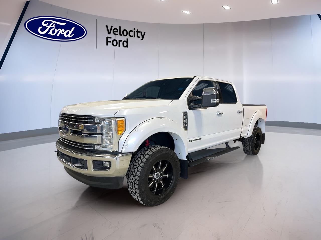 Built to handle hard work and long days with ease, this used 2017 Ford Super Duty F-350 SRW 4WD Crew Cab 6-3/4 Ft Box Lariat delivers serious diesel strength, proven capability, and premium comfort. Finished in White with a Black interior, this four-door heavy-duty pickup is ready for towing, hauling, and daily driving in Moose Jaw.

With its 6.7-litre diesel engine, 6-speed automatic transmission, and four-wheel drive, this Ford Super Duty F-350 SRW 4WD Crew Cab 6-3/4 Ft Box Lariat brings the muscle needed for demanding jobs. It also offers the comfort and convenience features many drivers want in a well-equipped truck, making it a smart fit for both work and family use.

FEATURES OF THE Super Duty F-350 SRW 4WD Crew Cab 6-3/4 Ft Box Lariat
»» Lariat trim adds upscale cabin comfort
»» Crew Cab offers roomy passenger space
»» Diesel power supports heavy-duty capability
»» Four-wheel drive adds year-round confidence

TRUCK FEATURES
»» Towing capacity rated at 5,533 kg
»» Short box supports versatile cargo needs
»» Rear tow hook adds utility
»» Side steps ease cabin entry

ADVANCED SAFETY FEATURES
»» Backup camera helps with reversing
»» Side impact airbags add protection
»» Stability control supports secure handling
»» Tire pressure monitoring aids awareness

PERFORMANCE AND EFFICIENCY
»» 6.7-litre diesel delivers strong pulling power
»» Six-speed automatic supports smooth shifting
»» Four-wheel drive improves traction year-round
»» Limited slip differential boosts grip

COMFORT AND CONVENIENCE
»» Heated front seats add cold-weather comfort
»» Dual-zone climate control helps everyone
»» Memory seats simplify repeat settings
»» Power windows add daily convenience

TECHNONOLGY AND CONNECTIVITY
»» Bluetooth integration supports hands-free calling
»» WiFi hotspot adds online access
»» Satellite radio expands entertainment choices
»» Steering wheel audio controls help focus

CARGO SPACE
»» 6-foot 3-inch box carries gear
»» Crew Cab adds interior storage flexibility
»» Rear trunk access supports easy loading
»» Spare tire adds worksite reassurance

AWARDS & RECOGNITIONS
»» Best Buy Heavy Duty Pickup, The Car Guide, 2017
»» Heavy Duty Pickup Truck Challenge winner, Auto123, 2017

WHAT OTHER OWNERS LIKE
»» Strong diesel towing performance under load
»» Spacious Crew Cab for passengers
»» Comfortable ride for heavy-duty truck
»» Useful technology for everyday driving

This used 2017 Ford Super Duty F-350 SRW 4WD Crew Cab 6-3/4 Ft Box Lariat stands out with a practical mix of toughness and refinement. Features such as cruise control, power steering, anti-lock braking system, heated mirrors, retractable mirrors, fog lights, automatic headlights, adjustable pedals, and an auto-dimming rearview mirror help make every trip easier.

Inside, this used 2017 Ford Super Duty F-350 SRW 4WD Crew Cab 6-3/4 Ft Box Lariat is designed for comfort and control. You will appreciate front air conditioning, automatic climate control, lumbar support for both front occupants, a power drivers seat, power passenger seat, memory mirrors, illuminated vanity mirrors, tinted windows, and a leather-wrapped steering wheel.

Sold by Velocity Ford in Moose Jaw, this diesel pickup is a strong option for drivers who need real truck capability without giving up comfort. Its blend of towing strength, useful features, and trusted Ford heavy-duty engineering makes it ready for the next job, the next trip, and the next season.

This 2017 Ford Super Duty F-350 SRW 4WD Crew Cab 6-3/4 Ft Box Lariats VIN is: 1FT8W3BT1HED88686.