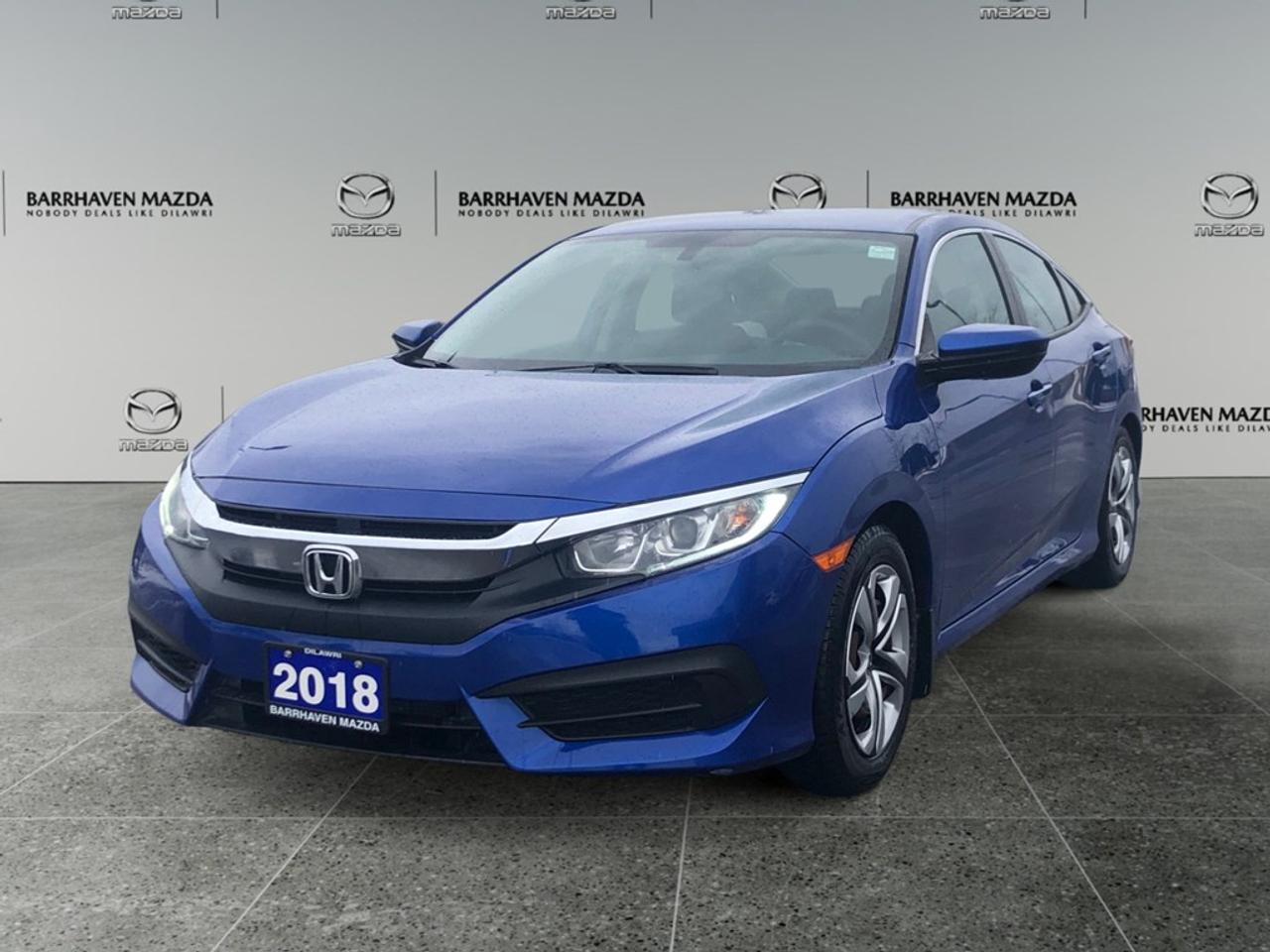 The 2018 Honda Civic Sedan LX Manual, in a vibrant blue, combines a thrilling driving experience with a front-wheel drive system that ensures impeccable handling. Its dynamic design is complemented by a sleek blue exterior, making every journey a statement of style. Inside, the Civic LX offers a blend of comfort and innovation. Youll enjoy features like air conditioning and keyless entry that enhance everyday convenience. The supportive heated front seats and modern power windows are tailored for both comfort and sophistication. Stay connected and safe with technology that includes Bluetooth connectivity and a smart device integration system. A backup camera is also in place, accompanied by advanced safety features like brake assist and cruise control, ensuring a secure drive every time. This makes the 2018 Honda Civic Sedan perfect for those who appreciate a blend of style, technology, and assured performance. If you value these qualities in a car, this Civic was designed with you in mind. Contact us today to learn more or to schedule a test drive.
