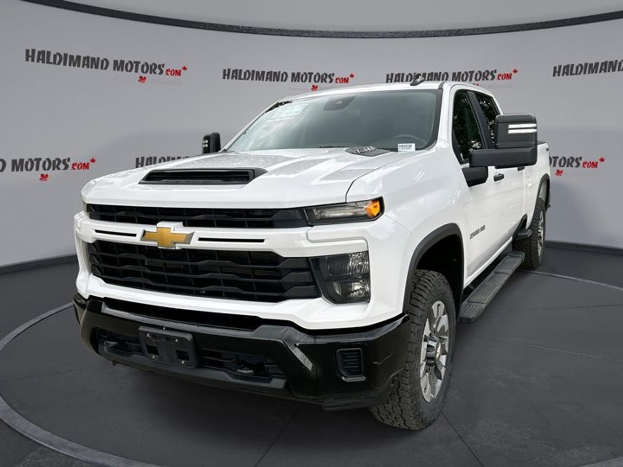 // ACCIDENT FREE!! //<br /><br />Built for hard work and long days on the road, this 2024 Chevrolet Silverado 2500 HD Custom Crew Cab 8 Box 4WD is a capable heavy-duty truck with the right features for towing, hauling, and everyday use. Finished in White with a Black interior, it presents a clean, professional look.<br /><br />This used 2024 Chevrolet Silverado 2500 HD Custom Crew Cab 8 Box 4WD has 56,561 km, a 6.6 L gas engine, and an automatic transmission. With four full doors, four-wheel drive, and a long 8-foot box, it is well suited for job sites, rural roads, and weekend towing duties.<br /><br />FEATURES OF THE Silverado 2500 HD Custom Crew Cab 8 Box 4WD | No Accidents<br /><br />   6.6 L gas V8 power<br />   Crew Cab with four full doors<br />   Long 8-foot cargo box included<br />   Four-wheel drive for added traction<br /><br />TRUCK FEATURES<br /><br />   Towing capacity rated at 9,070 kg<br />   Trailer hitch ready for heavy loads<br />   Rear tow hook adds utility<br />   Limited slip differential aids traction<br /><br />ADVANCED SAFETY FEATURES<br /><br />   Backup camera helps with reversing<br />   Anti-lock braking system supports control<br />   Stability control adds driving confidence<br />   Head and side airbags included<br /><br />PERFORMANCE AND EFFICIENCY<br /><br />   6.6 L gas engine delivers strength<br />   Automatic transmission shifts smoothly daily<br />   Four-wheel drive handles rough conditions<br />   Off-road tires support added grip<br /><br />COMFORT AND CONVENIENCE<br /><br />   Cruise control helps on longer trips<br />   Front air conditioning keeps cabin cool<br />   Rear climate control adds comfort<br />   Power windows offer easy operation<br /><br />TECHNONOLGY AND CONNECTIVITY<br /><br />   Apple CarPlay supports smartphone integration<br />   Android Auto keeps apps accessible<br />   Bluetooth integration enables hands-free calling<br />   WiFi hotspot helps keep devices connected<br /><br />CARGO SPACE<br /><br />   Eight-foot box supports large cargo<br />   Crew Cab adds interior carrying room<br />   Rear trunk access improves loading ease<br />   Spare tire included for backup<br /><br />AWARDS & RECOGNITIONS<br /><br />The 2024 Chevrolet Silverado 2500 HD Custom Crew Cab 8 Box 4WD is part of Chevrolets respected heavy-duty truck lineup, known for strong work capability and durable design. Its gas-powered 6.6 L engine gives dependable performance for drivers who need solid pulling power without stepping into a diesel setup.<br /><br />Inside, this truck keeps things practical and useful. The roomy Crew Cab layout gives passengers generous space, while features like rear air conditioning, power steering, push button start, and automatic door locks help make daily use simple. Heated mirrors and turn signal mirrors also add welcome convenience in changing weather.<br /><br />This 2024 Chevrolet Silverado 2500 HD Custom Crew Cab 8 Box 4WD is equipped for connected driving with satellite radio, Bluetooth integration, Apple CarPlay, Android Auto, and a WiFi hotspot. These features help keep work calls, music, navigation, and apps close at hand when you are on the move.<br /><br />For drivers who tow often, the trailer hitch, rear tow hook, four-wheel drive system, and off-road tires add real-world confidence. Adaptive cruise control is also a valuable feature on highway runs, helping reduce stress over longer distances while supporting a more relaxed drive.<br /><br />WHAT OTHER OWNERS LIKE<br /><br />   Strong towing and hauling capability<br />   Spacious Crew Cab passenger room<br />   Confident four-wheel drive performance<br />   Easy-to-use technology and controls<br /><br />This 2024 Chevrolet Silverado 2500 HD Custom Crew Cab 8 Box 4WD | No Accidents s VIN is: 1GC4YME72RF255153.<br /><br />WHY CHOOSE US? <br /><br />Honest & Transparent Buying Experience: Weve been a trusted name in business since 1984.<br /><br />STRAIGHTFORWARD PRICING:<br />Our Advertised Price Includes:<br />>>Safety Certification (No separate fee!)<br />>>30-Day 100% Mechanical Warranty<br />>>FREE Carfax History Report.<br />>>No upcharge for paying cash.<br />(Prices Exclude HST and Licensing Fees only.)<br /><br />>>Browse 300+ vehicles all in ONE LOCATION<br /><br />EASY FINANCING: Great rates & open loans<br /><br />WE BUY CARS: Get Top Dollar for your trade-in, or sell us your vehicle for CASH! Even if you dont buy from us!<br /><br />STOP BY TODAY<br />Treat yourself - stop by Haldimand Motors Ltd. located at 42 Talbot St E, Cayuga, ON N0A 1E0 to make this car yours today!<br /><br />https://www.haldimandmotors.com/used/stock-460206.html
