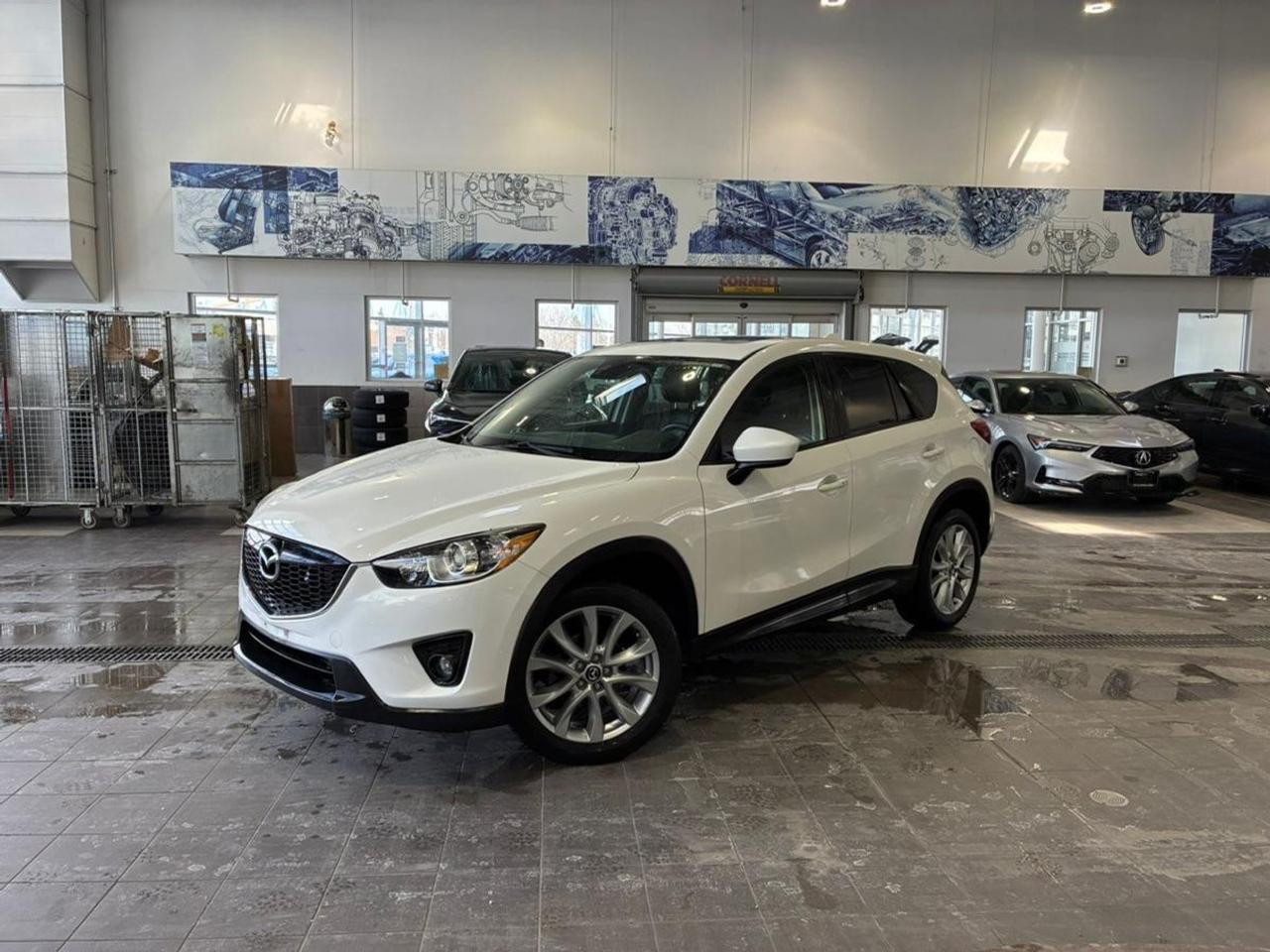 Bluetooth, Market Value Pricing, Not a Rental, Local Trade, ** All vehicles are all in priced, No additional fees are applied., 19 Alloy Wheels, 4-Wheel Disc Brakes, Air Conditioning, Driver door bin, Front dual zone A/C, Garage door transmitter: HomeLink, Heated Front Seats, Occupant sensing airbag, Outside temperature display, Panic alarm, Power door mirrors, Power driver seat, Rear window wiper, Remote keyless entry, Telescoping steering wheel.

Recent Arrival! 2014 Mazda CX-5 Grand Touring
SKYACTIV&reg; 2.5L 4-Cylinder DOHC 16V 6-Speed Automatic AWD


CARFAX Canada No Reported Accidents CARFAX Canada One Owner

** All vehicles are all in priced, No additional fees are applied. This vehicle is being sold as is, unfit, not e-tested and is not represented as being in roadworthy condition, mechanically sound or maintained at any guaranteed level of quality. The vehicle may not be fit for use as a means of transportation and may require substantial repairs at the purchasers expense. It may not be possible to register the vehicle to be driven in its current condition.

Awards:
  * IIHS Canada Top Safety Pick, Top Safety Pick+   * Canadian Car of the Year AJACs Best New Small Car (over $21,000)
Reviews:
  * Mazda CX-5 owners tend to rate their machines highly on all attributes relating to style, quality, feature content, and fuel efficiency. The upscale look and feel to much of the cabin is a common praise point, as is the real-world mileage. Spirited handling and steering and generally good ride quality help round out the package, and the AWD system is noted for invisibly enhancing performance and grip in slippery conditions. Source: autoTRADER.ca