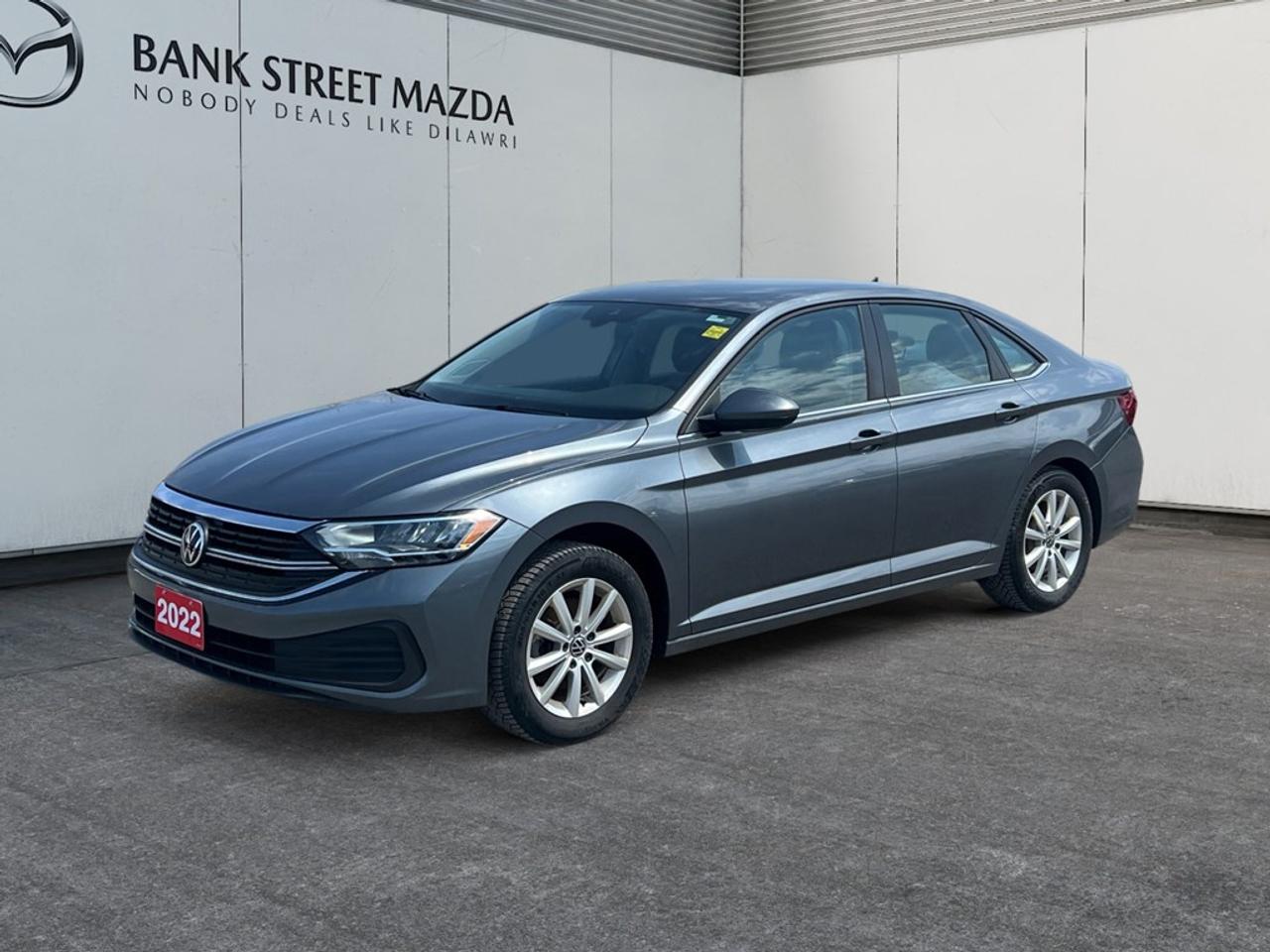 The 2022 Volkswagen Jetta Comfortline in sleek gray is designed to impress with its sophisticated sedan styling and fuel-efficient FWD driveline. Enjoy precise handling on the road thanks to its automatic transmission and performance-tuned dynamics. This sedans exterior exudes elegance and confidence, while the interior envelops you in comfort with premium leatherette door trims and heated front seats, perfect for cold Canadian winters. Keyless entry and power seats add a layer of convenience, ensuring every journey is effortlessly smooth. Embrace modern technology with a well-integrated suite of features, including a user-friendly Bluetooth connection, smart device integration, and a Wi-Fi hotspot to keep everyone connected on the go. Safety is paramount with advanced systems like lane assist, a backup camera, adaptive cruise control, and brake assist, making every drive a secure one. This Jetta is ideal for those who value comfort, technology, and reliability in their daily commute. If youre looking for a sedan that offers both style and substance, contact our dealership today to learn more about what the 2022 Volkswagen Jetta Comfortline has to offer.
