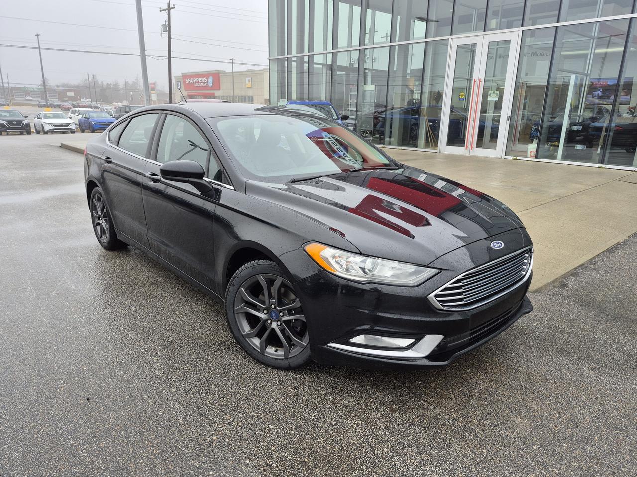 <p data-start=166 data-end=455>The <strong data-start=170 data-end=193>2018 Ford Fusion SE</strong> is the perfect blend of modern style, smooth performance, and everyday practicality. With its sleek exterior design and refined interior, this midsize sedan delivers a comfortable and confident driving experience whether youre commuting or hitting the highway.</p><p data-start=457 data-end=693>Under the hood, the Fusion SE offers a responsive and fuel-efficient engine lineup, paired with a smooth-shifting automatic transmission for an easy, enjoyable drive. Its composed handling and quiet ride make it a standout in its class.</p><p data-start=695 data-end=1094>Inside, you&rsquo;ll find a well-appointed cabin featuring premium cloth seating, a power-adjustable driver&rsquo;s seat, and a user-friendly layout designed with comfort in mind. Stay connected with Bluetooth, voice controls, and available infotainment features, while enjoying added conveniences like keyless entry, cruise control, and a spacious trunk for all your gear.</p><p data-start=1096 data-end=1247>Safety is also a strong point, with multiple airbags, a rearview camera, and available driver-assist features to give you peace of mind on every drive.</p><p data-start=1249 data-end=1389>If youre looking for a stylish, reliable, and fuel-efficient sedan with plenty of features, the 2018 Ford Fusion SE is an excellent choice.</p>
