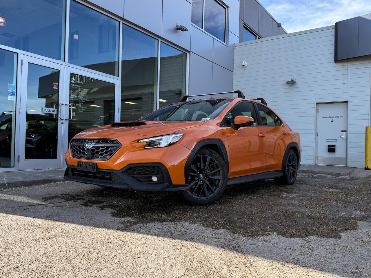 Experience the thrilling performance and distinctive style of this pre-owned 2022 Subaru WRX Sport-tech CVT in eye-catching Orange with a sleek black interior. Powered by a responsive 2.4L Boxer engine paired with Subarus advanced 8-speed CVT and full-time AWD, this WRX delivers exhilarating agility and confidence on every road.Enjoy elevated comfort with heated sport bucket seats featuring ultrasuede inserts, dual-zone automatic climate control, and premium technology including a touchscreen navigation system, adaptive cruise control, and remote engine start. Safety is paramount with lane keep assist, pre-collision braking, reverse automatic braking, and seven airbags ensuring peace of mind.Sporty 18 alloy wheels with Dunlop performance tires complement the aggressive styling highlighted by LED adaptive headlights and a rear lip spoiler. Whether daily commuting or spirited drives, this WRX Sport-tech offers a perfect blend of performance, luxury, and advanced safety features.Drive the legend  schedule your test drive today and take home a Subaru WRX ready to elevate your driving experience!Vehicle previously registered in Brittish ColumbiaVehicle has claims of $1543.38, $4972.58, $5029.27, $15603.35, $3133.90, $1130.62Go Mazda is a AMVIC licenced business