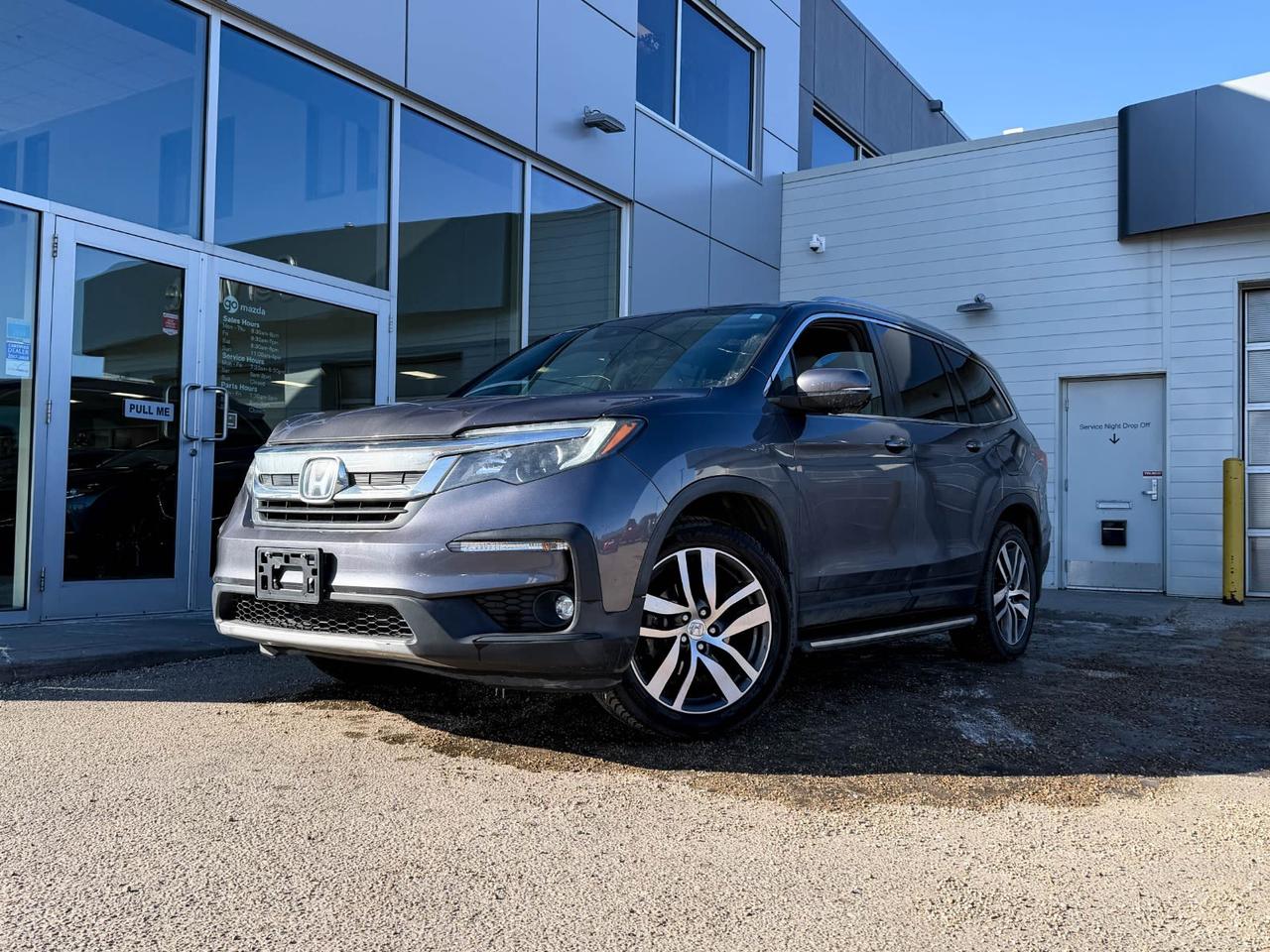 Discover reliable comfort and advanced technology with this pre-owned 2019 Honda Pilot EX-L Navi AWD in sleek Modern Steel Metallic. Powered by a smooth 3.5L V6 engine paired with a responsive 6-speed automatic transmission, this SUV offers confident all-wheel-drive capability and a robust 2,650 kg GVWR.Inside, enjoy heated leather-trimmed front seats with power adjustments and memory settings, while your entire family benefits from seating for 8 across three rows. Stay connected and on track with Hondas Satellite-Linked Navigation, a 7-inch touchscreen, SiriusXM radio, wireless audio streaming, and multiple USB ports.Safety is top-notch with features like lane departure prevention, forward collision mitigation, multi-angle rearview camera, front and rear parking sensors, and six airbags. Practical touches include a power liftgate, roof rails, and ample cargo space with smart storage solutions.Whether its family road trips or daily commutes, this Honda Pilot EX-L Navi AWD provides dependable performance with a premium feel. Contact us today to test drive this versatile and well-equipped SUV!Go Mazda is an AMVIC licensed business.This vehicle has been registered in the province ofOntario, and is showing CarFax incidents in the amount of$1,662.67 and $1,868.00