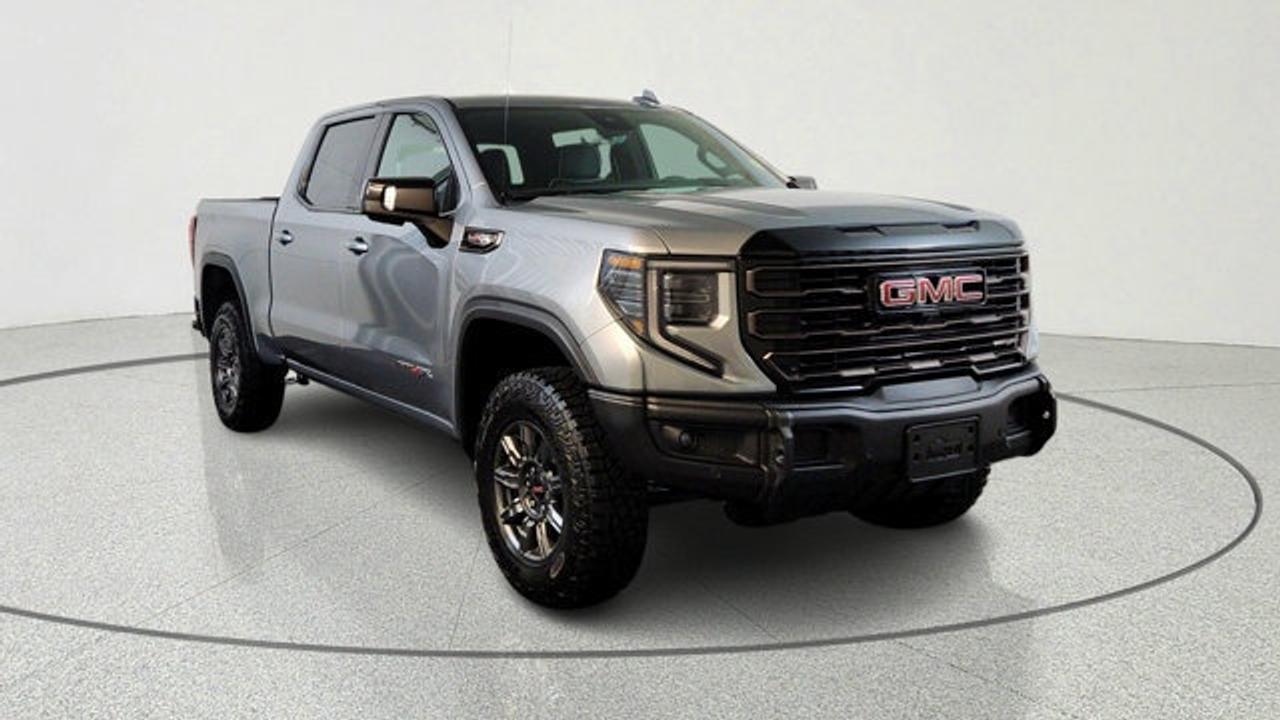 The 2026 GMC Sierra 1500 AT4X is a premium off-road-focused pickup that combines rugged capability with advanced engineering. Features front and rear electronic locking differentials, Multimatic DSSV dampers, and a factory-installed suspension lift for superior performance on challenging terrain. Its equipped with a 6.2L V8, along with impressive towing capability and specialized off-road hardware like skid plates and an AEV steel front bumper with winch capability. Inside, the AT4X delivers a high-end experience with full-grain leather seating, 16-way power heated and ventilated seats with massage, and advanced technology including a 13.4-inch infotainment system with Google built-in and a 12.3-inch digital driver display.