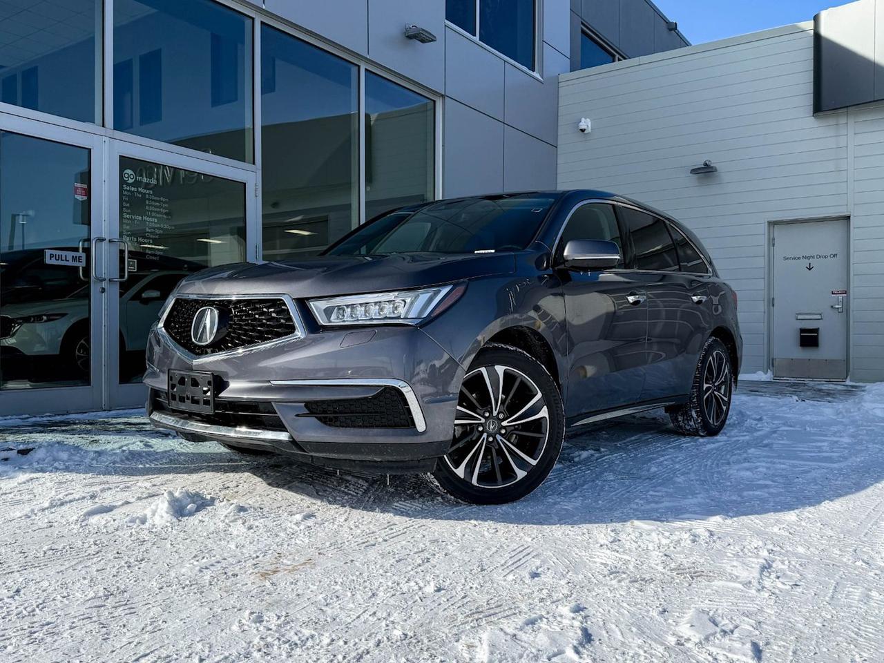 Discover luxury, performance, and advanced technology all wrapped into the sleek Grey 2020 Acura MDX Tech SH-AWD. Powered by a robust 3.5L SOHC i-VTEC V6 engine paired with a smooth 9-speed automatic transmission, this SUV delivers confident performance with its full-time all-wheel drive and sophisticated driver-selectable modes.Step inside to experience premium comfort with heated leather-trimmed front seats, multi-zone automatic climate control, and an intuitive infotainment system featuring the Acura/ELS Studio premium audio and an 8-inch touchscreen with integrated navigation. Safety is paramount with forward collision mitigation, lane departure prevention, blind spot warning, and a comprehensive 7-airbag system.With spacious 7-passenger seating, power liftgate, rear parking sensors, and a host of convenience features like smart key access and power-adjustable seating with memory settings, the MDX Tech SH-AWD is perfect for families and adventure seekers alike.Experience elegant design, cutting-edge safety, and performance-driven luxuryschedule your test drive today and elevate your driving experience with this exceptional 2020 Acura MDX Tech SH-AWD.Go Mazda is an AMVIC licensed business.This vehicle was previously registered in the province of Ontario and Manitoba