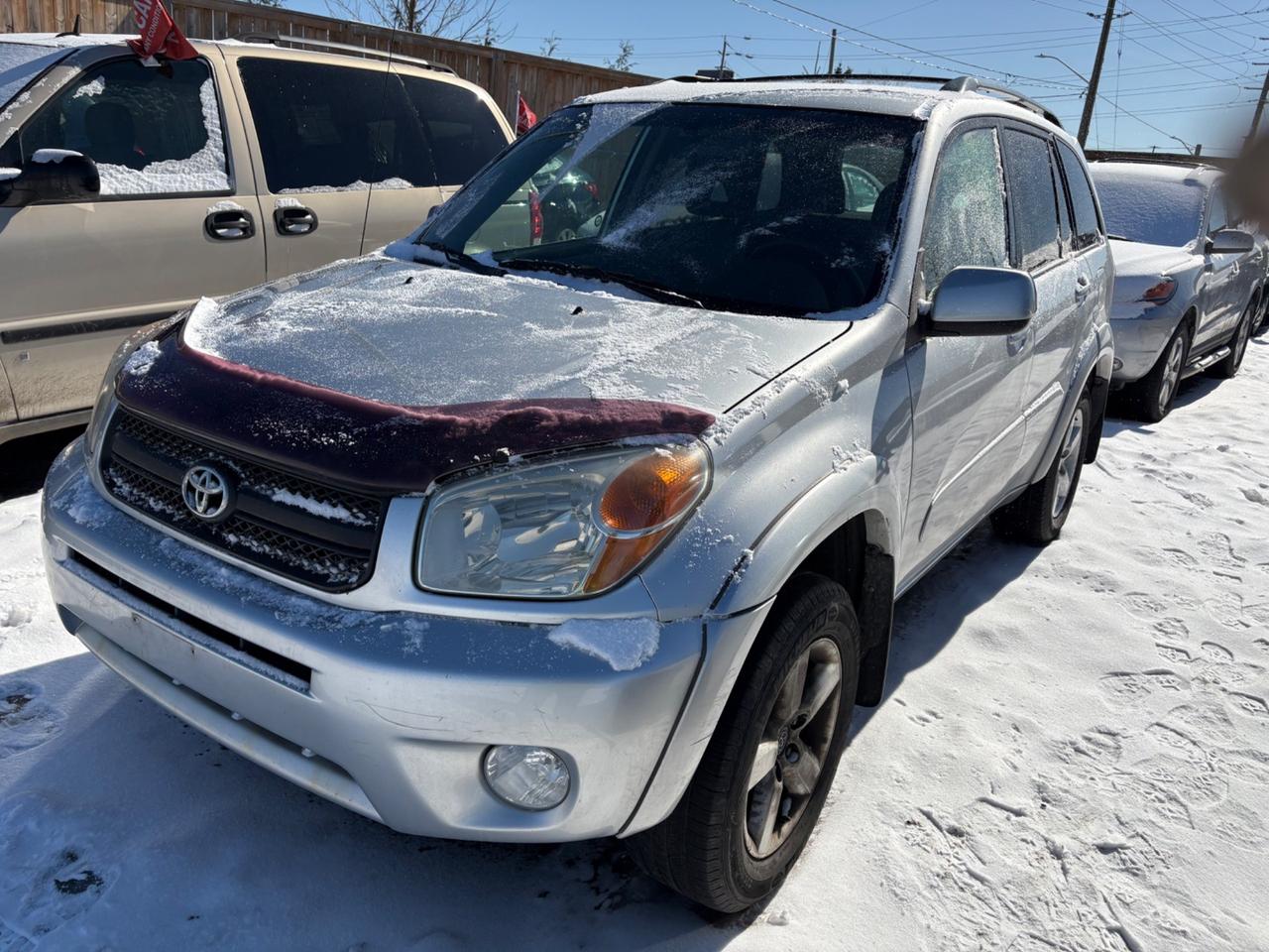 2004 Toyota RAV4. Silver exterior, and grey cloth interior. The vehicle odometer is 253,609 km and runs with no engine light on. There is a damaged front bumper and rust on the frame at drivers door as seen in pics. This vehicle has no brakes, and cannot be driven. The vehicle is sold as is and may require additional work. We do not perform mechanical checks or provide safety inspections.