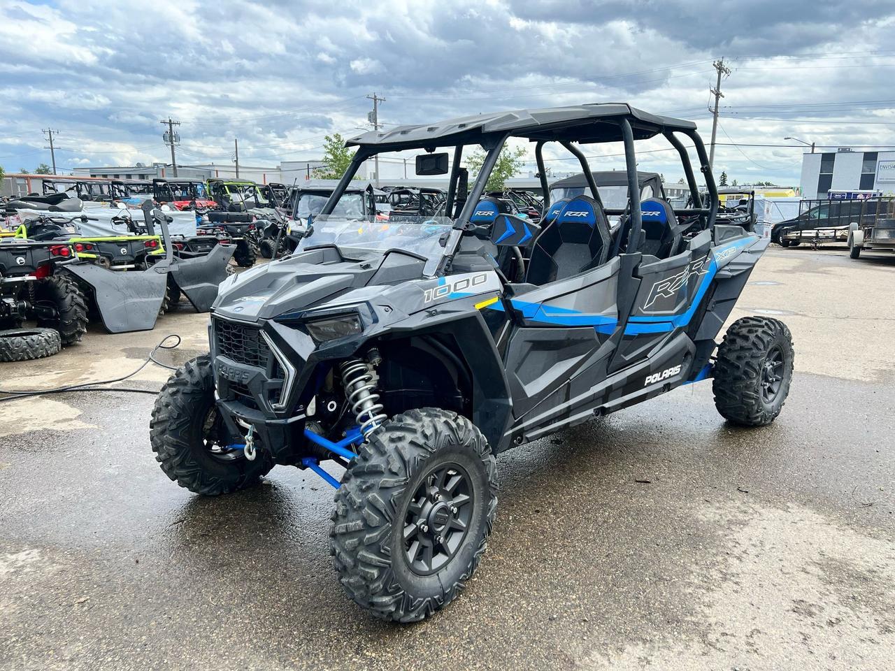 <p data-start=133 data-end=469>The 2022 Polaris RZR XP 4 1000 Ultimate is built for riders who demand performance, comfort, and cutting-edge tech&mdash;without leaving the crew behind. Powered by a proven 110 HP ProStar 1000 H.O. engine, this 4-seater delivers thrilling acceleration, crisp throttle response, and the strength to conquer rugged terrain with confidence.</p><p data-start=133 data-end=469>&nbsp;</p><p data-start=471 data-end=874>Designed for trail domination and all-day adventure, the Ultimate trim comes factory-equipped with FOX 2.5 Podium Live Valve shocks, offering intelligent, on-the-fly suspension adjustments that adapt to the terrain in real-time. High-clearance A-arms, 30&rdquo; Maxxis Carnivore tires, and a 64&rdquo; stance ensure you stay planted and smooth over rocky trails, deep ruts, and high-speed corners alike.</p><p data-start=471 data-end=874>&nbsp;</p><p data-start=876 data-end=1207>Step inside and you&rsquo;re greeted with a premium cab loaded with Ride Command technology, a 7&rdquo; touchscreen display, GPS navigation, front and rear cameras, and Rockford Fosgate Stage 2 audio&mdash;built to elevate every ride. Bolstered bucket seats, full doors, and LED lighting throughout complete the Ultimate package.</p><p data-start=876 data-end=1207>&nbsp;</p><p data-start=1209 data-end=1417>Whether you&rsquo;re chasing sunsets, carving trails with friends, or exploring off-grid terrain, the 2022 RZR XP 4 Ultimate is the ultimate blend of performance, technology, and utility for riders who want it all.</p><p data-start=113 data-end=424>&nbsp;</p><p data-start=1419 data-end=1595 data-is-last-node= data-is-only-node=>Call or message us today to learn more about financing, trade-in options, or delivery across Canada. The RZR XP 4 1000 Ultimate &mdash; bring the whole crew, and don&rsquo;t hold back.</p>