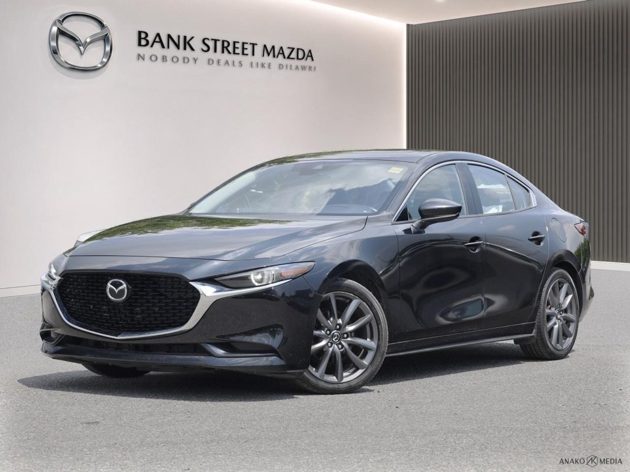 Elevate your daily drive with this exceptional 2019 Mazda Mazda3 GT, a sophisticated sedan engineered for thrilling performance and unparalleled comfort. This striking 4-door i-ACTIV All-Wheel Drive model combines Mazdas renowned KODO design philosophy with the advanced technology of the premium GT trim. With 94,162 kilometers, this Mazda3 GT stands ready to deliver an engaging and reliable driving experience, showcasing its meticulous design and robust build quality. Step inside and discover a cabin meticulously crafted for the discerning driver. Experience instant luxury with sumptuous Leather Seats and stay cozy on cooler days thanks to the Heated Seats and Heated Steering Wheel. Connectivity is seamless with Apple CarPlay / Android Auto integration and Bluetooth, ensuring your favorite apps and media are always at your fingertips, all channeled through an immersive Premium Bose Audio system. Navigate with confidence using the integrated Navigation System and enjoy the open sky through the Power Moonroof / Sunroof. Convenience is paramount with Keyless Entry & Start, Adaptive Cruise Control for effortless highway travel, and advanced driver-assistance features like Blind Spot Monitor, Lane Departure Warning, and Rear Parking Assist to enhance safety and awareness on every journey. Under the hood, this Mazda3 GT is powered by a responsive 2.5L SKYACTIV-G DOHC 16-Valve I4 engine, paired with a smooth 6-Speed SKYACTIV-Drive Automatic Transmission. This powertrain delivers an impressive 186 horsepower and 186 lb-ft of torque, providing spirited acceleration while maintaining remarkable fuel efficiency at 9.2 L/100km city and 7 L/100km highway (25.6 MPG city, 33.6 MPG highway). The intelligent i-ACTIV All-Wheel Drive system ensures superior traction and control in various driving conditions, making it an ideal companion for any adventure. Key Features & Specifications: Engine: 2.5L SKYACTIV-G DOHC 16-Valve I4 (186 hp, 186 lb-ft torque) Transmission: 6-Speed SKYACTIV-Drive Automatic Drive Type: i-ACTIV All-Wheel Drive (AWD) Fuel Economy: 9.2 L/100km city / 7 L/100km highway Premium Leather Seats Heated Front Seats and Heated Steering Wheel Power Moonroof / Sunroof Apple CarPlay / Android Auto Integration Bluetooth Hands-Free Connectivity Navigation System (MAZDA CONNECT) Bose Premium Audio System with 12 Speakers and Satellite Radio (SiriusXM compatible) Adaptive Cruise Control (Mazda Radar Cruise Control - MRCC) Keyless Entry & Push Button Start Lane Departure Warning (Lane-Keep Assist System - LAS) Blind Spot Monitor (Advanced Blind Spot Monitoring - ABSM) Rear Parking Assist (Exterior parking camera rear, rear parking sensors) Dual-Zone Automatic Climate Control Power Driver Seat with Memory Function and Lumbar Support Heads-Up Display (Active Driving Display) Auto-Dimming Rearview and Door Mirrors Homelink Garage Door Transmitter Full LED Lighting (Headlights, Taillights, DRLs) 18-inch Alloy Wheels Forward Collision Mitigation (Smart City Brake Support - SCBS) Rear Collision Mitigation (Smart Brake Support Rear - SBS-R) This 2019 Mazda Mazda3 GT is more than just a car; its a testament to Mazdas commitment to driving pleasure and sophisticated design. Dont miss your opportunity to own this well-equipped, high-performance sedan. Contact us today to schedule your personalized test drive!
