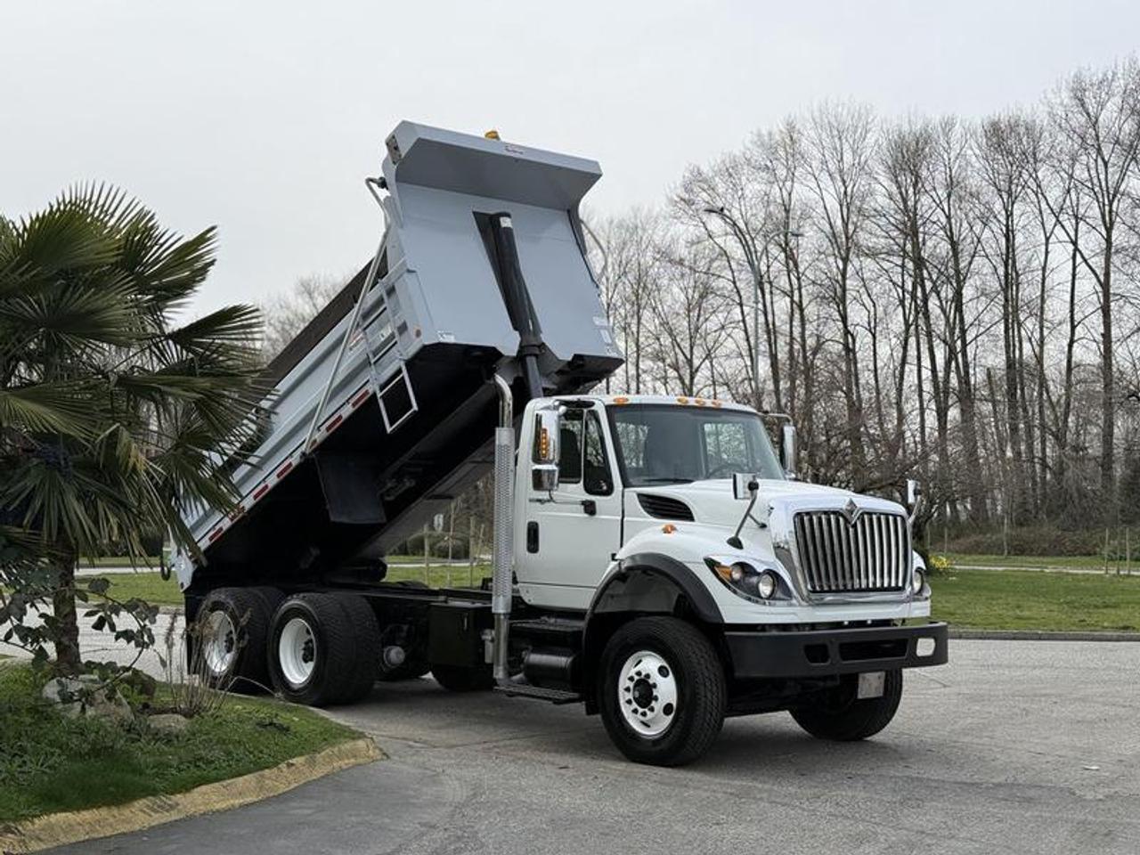 This 2014 International WorkStar 7500 tandem dump truck is equipped with a 9.3L inline-6 diesel engine, automatic transmission, and 6x4 drivetrain, paired with air brakes for heavy-duty operation. It features a Henderson MK E 15-yard dump box measuring approximately 15.5 feet in length with 36-inch sides, along with a power tarp system and pneumatic high-lift tailgate for efficient loading and unloading. Outfitted with a Parker Chelsea PTO, this unit also includes a 90,000 lb pintle trailer hitch, trailer brake controls, and gladhand connections for towing capability. Additional features include engine brake, differential lock, cruise control, air conditioning, AM/FM radio with Bluetooth and CD player, as well as power windows, locks, and mirrors. Finished in white with a gray cloth interior, this truck is well-suited for commercial hauling, construction, or fleet use. This item is currently OFFSITE. You must register an appointment with our office to schedule an offsite viewing. Appointments must be made a minimum of one business day in advance (and as defined by the days that Repo.com is open for business) before your appointment can be scheduled and confirmed. We may, at our own discretion, instead opt to transport smaller items to Repo.coms main yard for viewing purposes.  $98,810.00 plus $375 processing fee, $99,185.00 total payment obligation before taxes.  Listing report, warranty, contract commitment cancellation fee, financing available on approved credit (some limitations and exceptions may apply). All above specifications and information is considered to be accurate but is not guaranteed and no opinion or advice is given as to whether this item should be purchased. We do not allow test drives due to theft, fraud, acts of vandalism and undetectable impaired driving. Instead we provide the following benefits: Complimentary Warranty (with options to extend), Limited Money Back Satisfaction Guarantee on Fully Completed Contracts, Contract Commitment Cancellation, and an Open-Ended Sell-Back Option. Ask seller for details or call 604-522-REPO(7376) to confirm listing availability.