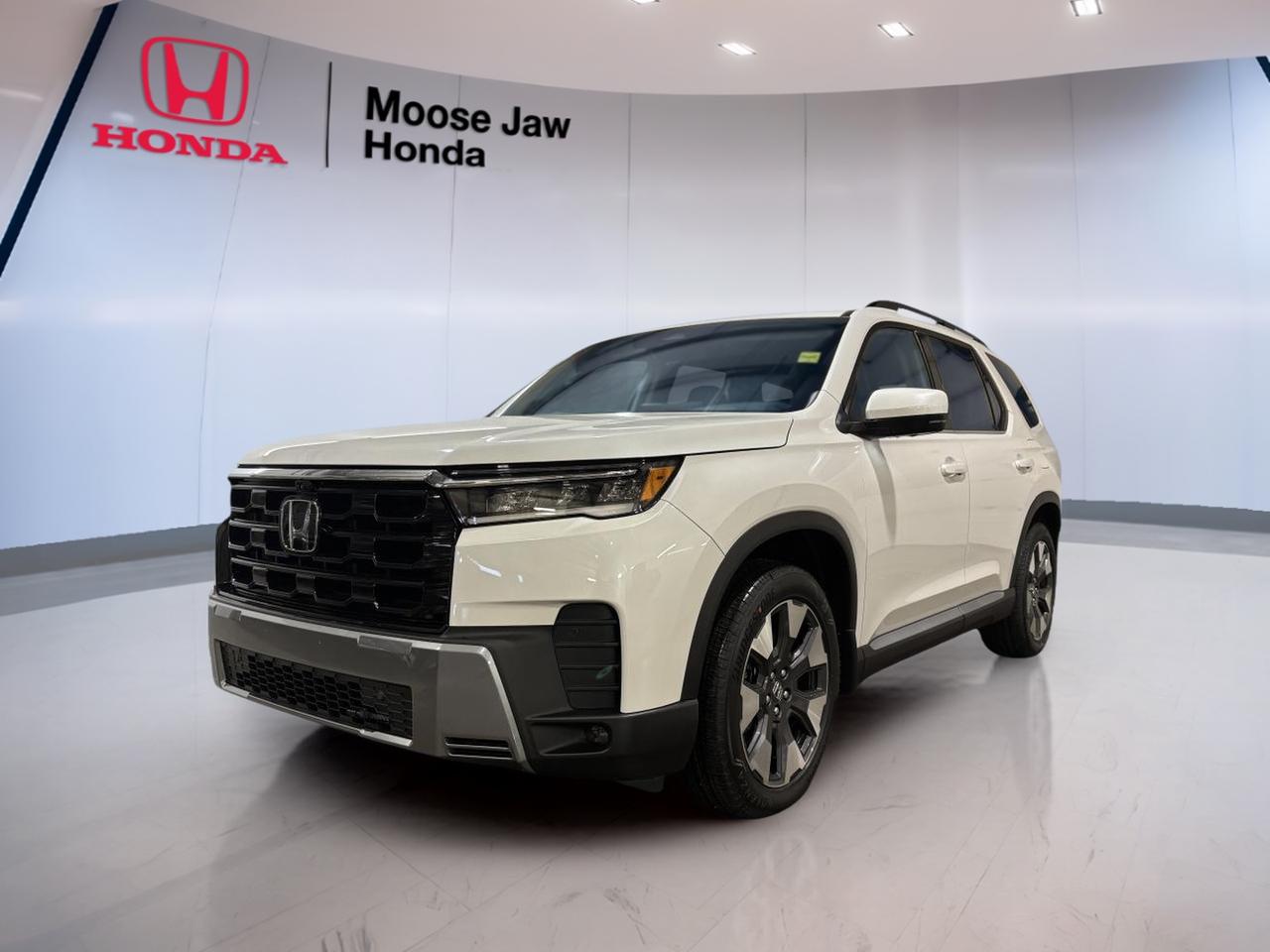 The 2026 Honda Pilot Touring is a brand-new SUV built for busy family life, weekend travel, and confident driving in every season. Finished in White with a Black interior, this three-row Honda delivers strong V6 power, smooth automatic shifting, and all-wheel drive capability for life in Moose Jaw and beyond.

At Moose Jaw Honda, this new 2026 Honda Pilot Touring stands out with a smart balance of comfort, practicality, and everyday confidence. Its 3.5-litre V6 engine works with a 10-speed automatic transmission for refined response, while the spacious cabin and flexible layout make it easy to handle passengers, gear, and daily routines.

FEATURES OF THE Pilot Touring
»» White exterior with clean, modern presence
»» Black interior with practical family focus
»» 3.5-litre V6 engine for strong response
»» All-wheel drive for year-round confidence

ADVANCED SAFETY FEATURES
»» Honda Sensing suite supports safer driving
»» Collision mitigation braking helps avoid impacts
»» Lane keeping assist adds highway confidence
»» Adaptive cruise control eases longer trips

PERFORMANCE AND EFFICIENCY
»» 3.5-litre V6 delivers smooth, strong power
»» 10-speed automatic supports refined gear changes
»» All-wheel drive boosts traction in weather
»» Dual VTC helps optimize engine response

COMFORT AND CONVENIENCE
»» Three-row cabin supports family travel needs
»» Spacious interior offers everyday versatility
»» Easy entry helps with passenger access
»» Quiet ride improves long-distance comfort

TECHNONOLGY AND CONNECTIVITY
»» Driver information display keeps data visible
»» Modern controls are clear and intuitive
»» Connectivity features support daily convenience
»» Smart cabin layout simplifies every drive

CARGO SPACE
»» Large rear cargo area handles gear
»» Flexible cabin supports changing storage needs
»» Three-row design adds useful versatility
»» Ideal for errands, trips, and sports

WHAT OTHER OWNERS LIKE
»» Smooth V6 power for daily driving
»» Comfortable ride quality on longer trips
»» Spacious cabin for families and cargo
»» Confident all-wheel drive in all seasons

The 2026 Honda Pilot Touring is designed for drivers who need real utility without giving up refinement. Its V6 powertrain gives this SUV strong passing ability and smooth highway performance, while the all-wheel drive system adds confidence on snowy Saskatchewan roads, wet pavement, and loose surfaces.

Inside, the cabin is made to support real life. The Black interior gives it a clean, upscale feel, while the roomy three-row layout makes space for family, friends, and extra cargo when needed. The result is an SUV that feels ready for school runs, road trips, and everything in between.

This brand-new 2026 Honda Pilot Touring also benefits from Hondas strong reputation for durability, thoughtful design, and user-friendly engineering. For shoppers in Moose Jaw looking for a well-rounded SUV with proven V6 performance, practical space, and modern safety, this Pilot Touring is a smart choice.

This 2026 Honda Pilot Tourings VIN is: 5FNYG1H71TB501751.<p> and everyday confidence. Its 3.5-litre V6 engine works with a 10-speed automatic transmission for refined response</p>
<p> modern presence
»» Black interior with practical family focus
»» 3.5-litre V6 engine for strong response
»» All-wheel drive for year-round confidence

ADVANCED SAFETY FEATURES
»» Honda Sensing suite supports safer driving
»» Collision mitigation braking helps avoid impacts
»» Lane keeping assist adds highway confidence
»» Adaptive cruise control eases longer trips

PERFORMANCE AND EFFICIENCY
»» 3.5-litre V6 delivers smooth</p>
<p> strong power
»» 10-speed automatic supports refined gear changes
»» All-wheel drive boosts traction in weather
»» Dual VTC helps optimize engine response

COMFORT AND CONVENIENCE
»» Three-row cabin supports family travel needs
»» Spacious interior offers everyday versatility
»» Easy entry helps with passenger access
»» Quiet ride improves long-distance comfort

TECHNONOLGY AND CONNECTIVITY
»» Driver information display keeps data visible
»» Modern controls are clear and intuitive
»» Connectivity features support daily convenience
»» Smart cabin layout simplifies every drive

CARGO SPACE
»» Large rear cargo area handles gear
»» Flexible cabin supports changing storage needs
»» Three-row design adds useful versatility
»» Ideal for errands</p>
<p> and sports

WHAT OTHER OWNERS LIKE
»» Smooth V6 power for daily driving
»» Comfortable ride quality on longer trips
»» Spacious cabin for families and cargo
»» Confident all-wheel drive in all seasons

The 2026 Honda Pilot Touring is designed for drivers who need real utility without giving up refinement. Its V6 powertrain gives this SUV strong passing ability and smooth highway performance</p>
<p> and everything in between.

This brand-new 2026 Honda Pilot Touring also benefits from Hondas strong reputation for durability</p>
<p> and user-friendly engineering. For shoppers in Moose Jaw looking for a well-rounded SUV with proven V6 performance</p>