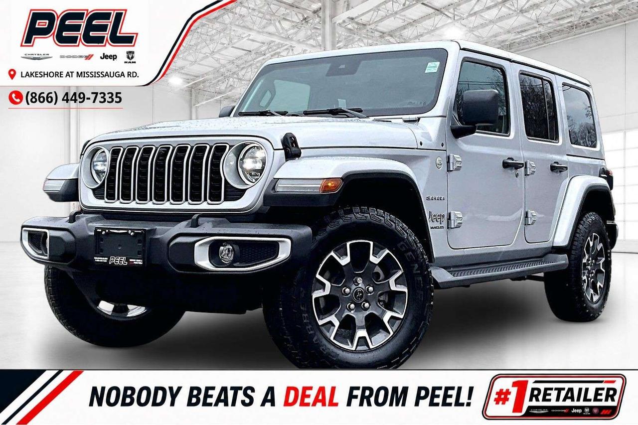 COME SEE WHY NOBODY BEATS A DEAL FROM PEEL! Your Source for ALL make and models used cars and trucks. 2024 Jeep Wrangler Sahara 4X4 | 2.0L Turbocharged I-4 Engine | Silver Zynith | Premium McKinley Leather Bucket Seats | Safety Group | Technology Group | Dual Top Group w/ Premium Sunrider Soft-top | Body-colour 3-piece Hard Top | Trailer Tow Group | Heated Seats | Heated Steering Wheel | Remote Start | LED Lighting Group | Uconnect 12.3" Touchscreen Display w/ Navigation | Alpine Premium Audio System | Wireless Apple CarPlay & Android Auto | Adaptive Cruise Control | Forward Collision Warning | Blind Spot Monitoring | Park-sense Rear Park Assist System | Integrated Off-road Camera | Mopar Plastic Door Sill Guards | Mopar All-weather Floor Mats | Side Steps w/ Diamond Plate Pattern | Class II Hitch Receiver One Owner Fully loaded with the options that actually matter, this 2024 Jeep Wrangler Sahara 4X4 in Silver Zynith is the kind of build that gives you the full Jeep experience with everyday comfort dialled in, powered by the 2.0L turbocharged engine delivering 270 hp and 295 lb-ft of torque for strong low-end pull and smooth highway driving. Inside, the premium McKinley leather bucket seats, heated seats, heated steering wheel, remote start, and dual-zone climate control create a cabin that feels genuinely upscale, while the massive 12.3-inch Uconnect touchscreen with navigation, wireless Apple CarPlay and Android Auto, and Alpine premium audio keep everything modern and easy to use. Safety and Technology Groups add Adaptive Cruise Control, Forward Collision Warning, Blind Spot Monitoring, Park-Sense rear park assist, and an integrated off-road camera, giving you confidence both in traffic and on the trail. The Dual Top Group is a major highlight, giving you both the body-colour 3-piece hard top for winter and the premium Sunrider soft top for quick open-air driving in warmer months, making this Wrangler far more versatile than most. Finished with LED lighting, Trailer Tow Group, a Class II hitch, Mopar all-weather mats, door sill guards, and diamond plate side steps, this is a rare, fully optioned Sahara that blends comfort, capability, and year-round usability in one highly desirable package. ______________________________________________________ FREE CarFax included! Click the CarFax link in the listing to view the report. Our advertised prices are for consumers/end users only and are not intended for dealer, wholesale, exporter, or broker purchases. ______________________________________________________ Peel Chrysler is based in Port Credit, Mississauga, and proudly serves customers across Ontario and Canada, including Toronto, Oakville, North York, Richmond Hill, Ajax, Hamilton, Niagara Falls, Brampton, Scarborough, Vaughan, London, Windsor, Cambridge, Kitchener, Waterloo, Brantford, Sarnia, Pickering, Huntsville, Milton, Woodbridge, Aurora, Newmarket, Orangeville, Georgetown, Markham, North Bay, Sudbury, Barrie, Oshawa, Kingston, Innisfil, and surrounding areas. Browse our selection of used cars, trucks, SUVs, vans, Ram, Jeep, Dodge, Chrysler, FIAT, and all makes and models at peelchrysler.com. ______________________________________________________ Disclaimer: Prices are for consumer/end-user purchases only. Advertised prices are all-in and include all dealer fees and charges, including the $499 loan processing fee where applicable, except HST, Fuel and Licensing, unless otherwise stated. Payments, rates, and terms are subject to approved credit and may change without notice. If a trade-in has an outstanding loan balance and Peel Chrysler is required to facilitate the lien payout, a $349 lien payout fee applies. Most pre-owned vehicles originally come with two keys; however, all Peel Chrysler pre-owned vehicles come standard with one key unless otherwise stated. Vehicle images may be digitally adjusted or enhanced for presentation purposes and may not always reflect the exact appearance of the vehicle. While we make every effort to ensure accuracy, vehicle details, features, options, materials, history, specifications, pricing, availability, and CarFax information should be verified with Peel Chrysler before purchase.