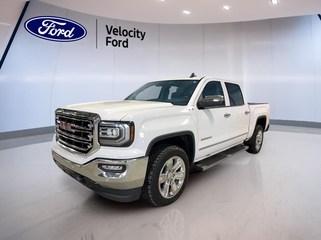 Built for hard work and long highway pulls, this 2018 GMC Sierra 1500 4WD Crew Cab Short Box SLT brings strong V8 power, a roomy four-door cabin, and proven truck capability. Finished in White with a Black interior, it has 141,159 km and an automatic transmission for smooth daily driving in Moose Jaw.

This used 2018 GMC Sierra 1500 4WD Crew Cab Short Box SLT is powered by a 6.2-litre unleaded engine and backed by four-wheel drive for added traction in changing Prairie weather. It blends confident towing strength with useful comfort and tech features that make every trip easier, whether for work or family use.

FEATURES OF THE Sierra 1500 4WD Crew Cab Short Box SLT

»» 6.2-litre V8 delivers strong passing power
»» Crew Cab adds spacious rear seating
»» Short Box supports versatile cargo hauling
»» Four-wheel drive boosts year-round traction

TRUCK FEATURES

»» Tows up to 5,306 kg confidently
»» Rear tow hook supports recovery needs
»» Limited slip differential aids traction
»» Retractable mirrors help tighter parking spaces

ADVANCED SAFETY FEATURES

»» Anti-lock brakes help maintain control
»» Stability control supports secure handling
»» Backup camera assists while reversing
»» Side curtain airbags add protection

PERFORMANCE AND EFFICIENCY

»» 6.2-litre engine delivers confident acceleration
»» Automatic transmission provides smooth shifting
»» Four-wheel drive handles changing road conditions
»» Power steering supports easy manoeuvres

COMFORT AND CONVENIENCE

»» Heated front seats add cold-weather comfort
»» Dual-zone climate control helps everyone
»» Remote starter warms cabin before driving
»» Memory settings simplify repeat adjustments

TECHNONOLGY AND CONNECTIVITY

»» Bluetooth integration supports hands-free calling
»» WiFi hotspot adds mobile online access
»» Satellite radio expands entertainment choices
»» Steering wheel audio controls simplify use

CARGO SPACE

»» Short Box handles tools and gear
»» Rear access helps load larger items
»» Four-door cabin adds storage flexibility
»» Spare tire supports roadside confidence

AWARDS & RECOGNITIONS

»» Top Safety Pick, Insurance Institute for Highway Safety, 2018

WHAT OTHER OWNERS LIKE

»» Strong V8 power for towing confidence
»» Comfortable cabin for daily driving
»» User-friendly controls and infotainment features
»» Four-wheel drive for winter capability

At Velocity Ford in Moose Jaw, this 2018 GMC Sierra 1500 4WD Crew Cab Short Box SLT stands out with practical equipment that drivers value every day. Cruise control, power windows, heated mirrors, electric mirrors, fog lights, HID headlights, tinted windows, adjustable pedals, and automatic door locks all add convenience without overcomplicating the truck.

Inside, this 2018 GMC Sierra 1500 4WD Crew Cab Short Box SLT offers a comfortable and functional layout with front air conditioning, automatic climate control, lumbar support for both front occupants, a power drivers seat, a power passenger seat, an auto-dimming rearview mirror, and illuminated vanity mirrors. The leather-wrapped steering wheel adds a premium touch to the driving experience.

For drivers who want a capable pickup with real V8 performance, this 2018 GMC Sierra 1500 4WD Crew Cab Short Box SLT delivers the essentials that matter most. It is well suited for towing, commuting, and year-round use, with the strength and everyday comfort expected from a full-size GMC truck.

This 2018 GMC Sierra 1500 4WD Crew Cab Short Box SLTs VIN is: 3GTU2NEJ7JG601235.