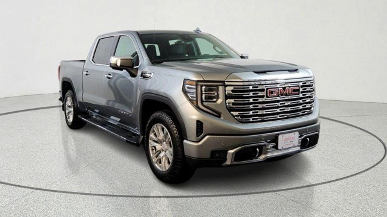 The 2026 GMC Sierra 1500 Denali is a premium full-size pickup that combines bold styling with advanced capability. Its 5.3L V8 provides with strong towing performance and a smooth ride enhanced by Adaptive Ride Control. Inside, it delivers a high-end experience with leather-appointed seating, authentic wood trim, heated and ventilated seats, a power sunroof and advanced technology such as a 13.4-inch touchscreen infotainment system and digital displays. It also emphasizes innovation and practicality with features like the MultiPro tailgate, up to 14 camera views including transparent trailer view, and a full suite of GMC Pro Safety driver-assistance systems for confidence on the road.