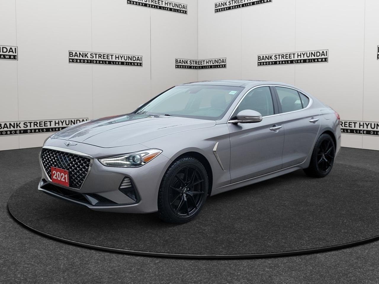 The 2021 Genesis G70 2.0T Elite AWD in stunning gray is a sophisticated and performance-driven sedan designed for an exhilarating all-wheel-drive experience. With its precise handling and automatic transmission, this vehicle promises driving pleasure and confidence on any road. Featuring a sleek exterior complemented by luxurious touches, the G70 evokes a sense of elegance and power. The refined styling carries into the interior, where youll find premium leather seats and a leather steering wheel that enhance your driving comfort. The large alloy wheels and commanding presence of the G70 make a statement wherever you go. Inside, the advanced technology is at your fingertips. The navigation system ensures you take the best routes, while the smart device integration keeps you connected on the go. Driver assistance features such as lane assist, adaptive cruise control, and a backup camera provide an extra layer of safety. Enjoy convenience with keyless entry, power seats, and cruise control, accented by luxurious features like the sunroof and cooled and heated seats. This Genesis G70 is ideal for drivers who value performance, luxury, and safety in one complete package. Whether you are a daily commuter or someone seeking weekend thrills, this sedan meets your expectations and more. Contact the dealership today to learn more about this impressive vehicle and elevate your driving journey.