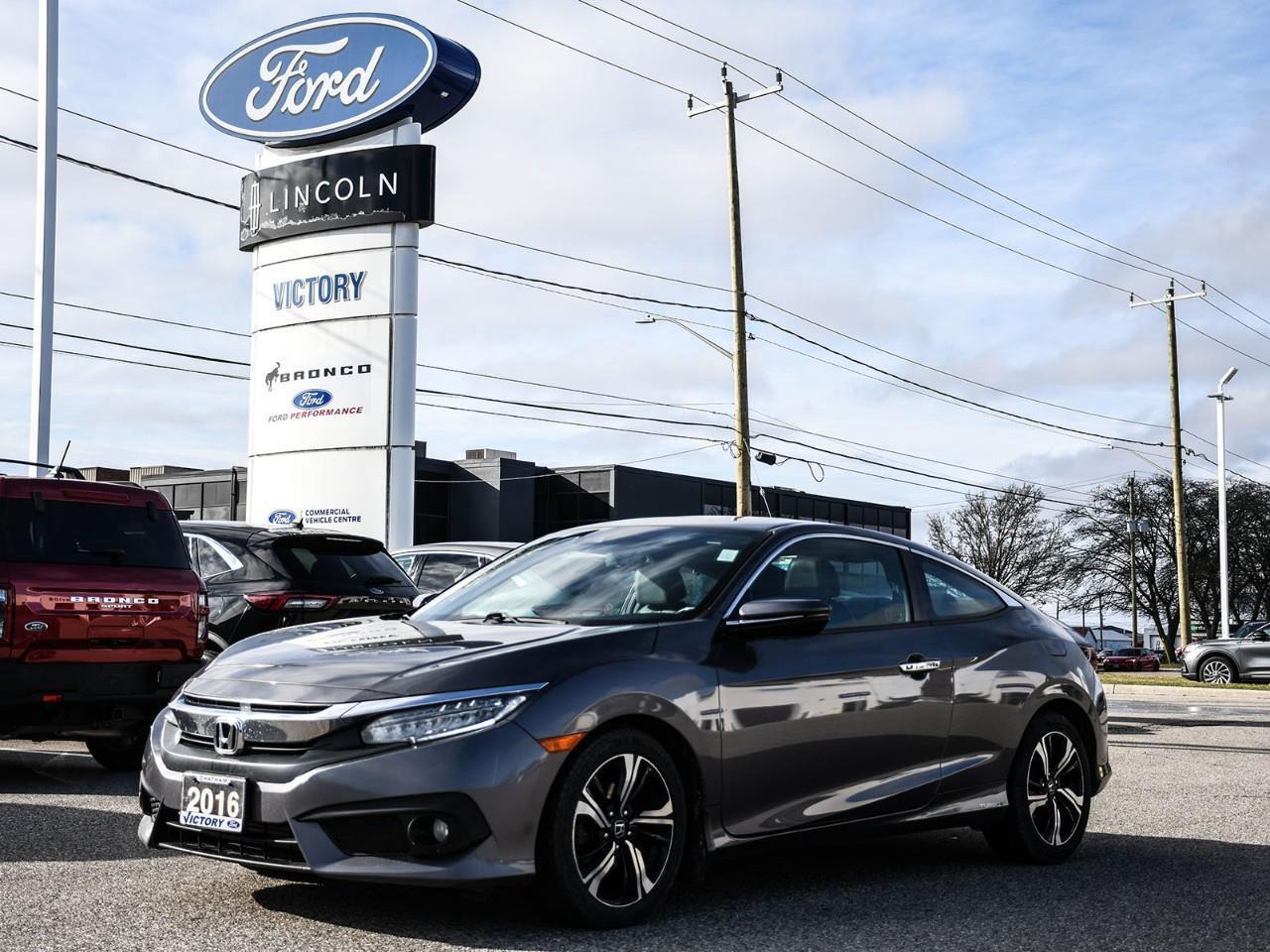 NOW AVAILABLE AT VICTORY FORD LINCOLN2016 Honda Civic Touring CoupeFully Loaded Touring Trim  Sporty Coupe Design  Advanced Technology  Fuel-Efficient Performance     This 2016 Honda Civic Touring Coupe blends sporty styling with premium features and impressive fuel efficiency. As a top-of-the-line Touring model, it offers advanced technology, upscale comfort, and a fun-to-drive experience in a sleek two-door design.POWER & PERFORMANCE       1.5L Turbocharged 4-Cylinder Engine         Continuously Variable Transmission (CVT)         Front-Wheel Drive         Responsive and Efficient Performance         Smooth and Sporty Driving Dynamics  TOURING FEATURES       Honda Sensing Safety Suite         Navigation System         Premium Audio System         Remote Engine Start         Smart Key with Push-Button Start  EXTERIOR FEATURES       LED Headlights         Power Sunroof         Heated Exterior Mirrors         Alloy Wheels         Sleek Coupe Styling  INTERIOR & COMFORT       Leather-Trimmed Seating         Heated Front Seats         Dual-Zone Climate Control         Power Driver Seat         Comfortable 5-Passenger Seating         Premium Interior Finishes  TECHNOLOGY       Touchscreen Infotainment System         Apple CarPlay & Android Auto         Bluetooth Connectivity         USB Ports         Digital Driver Display  SAFETY & DRIVER ASSISTANCE       Honda Sensing         Adaptive Cruise Control         Lane Keeping Assist         Collision Mitigation Braking System         Rear View Camera         Lane Departure Warning  HIGHLIGHTS       Touring Trim Level         Sporty Coupe Design         Turbocharged Engine         Premium Features Throughout         Advanced Safety Technology         Excellent Fuel Efficiency  Special Offer:     Peace of Mind Included: 3-Month Comprehensive Warranty (for vehicles under 10 years old & under 160,000 km) No-Haggle, Live Market Pricing  Transparent & Competitive All-Inclusive Pricing: Fees, Reconditioning, and Full Detailing Included (Taxes & Licensing Extra)Additional Details:     Keys: Standard with one key. Additional keys (if provided by the previous owner) included at no cost. Optional key purchases available upon request.     Visit Victory Ford Lincoln Today Schedule your appointment to experience this exceptional vehicle.
