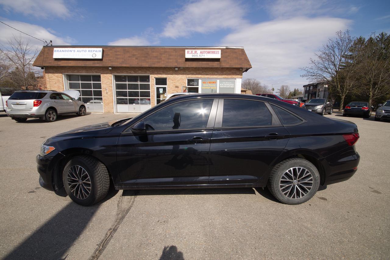 <p>Looking for a stylish and reliable sedan? Feast your eyes on this pristine 2019 Volkswagen Jetta Highline, available now at R.E.R. Automobiles Ltd. This beauty boasts a sleek white exterior that perfectly complements its sophisticated black interior, making a statement wherever you go. With only 92,362 km on the odometer, this Jetta is ready to provide you with years of comfortable and enjoyable driving. Its automatic transmission and front-wheel drive ensure a smooth and responsive ride, perfect for navigating city streets or embarking on weekend getaways.</p><p>This 2019 Jetta Highline is packed with features designed to enhance your driving experience. Step inside and youll immediately notice the premium feel, with comfortable seating and a thoughtfully designed cabin. This sedan is the perfect combination of practicality and style, making it an excellent choice for individuals, couples, or small families. Visit R.E.R. Automobiles Ltd today and experience the quality and performance of this exceptional Volkswagen Jetta for yourself.</p><p>Here are some of the standout features of this 2019 Volkswagen Jetta Highline:</p><ul><li><strong>Sunroof:</strong> Let the sunshine in with the integrated sunroof.</li><li><strong>Heated Front Seats:</strong> Experience cozy comfort on chilly Canadian mornings.</li><li><strong>Keyless Entry and Push Button Start:</strong> Enjoy the convenience of keyless access.</li><li><strong>Touchscreen Infotainment System:</strong> Stay connected and entertained with ease.</li><li><strong>Advanced Driver Assistance Systems:</strong> Drive with confidence, knowing you have added safety features.</li></ul><p><strong><em>Powered by AutoIntelligence&trade;</em></strong> Vehicle information has been generated using artificial intelligence and is provided for informational purposes only. While efforts are made to ensure accuracy, please confirm all details directly with the dealer.</p>