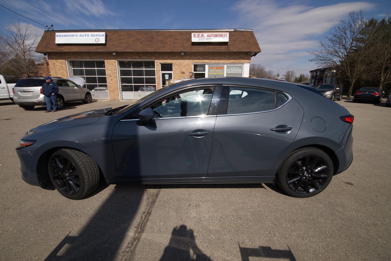 <p>Looking for a stylish and reliable sedan that offers a premium driving experience? Look no further than this 2020 Mazda MAZDA3 GT, available now at R.E.R. Automobiles Ltd. This sleek gray sedan, with its sophisticated black interior, is the perfect blend of practicality and luxury. Whether youre navigating city streets or embarking on a weekend getaway, the MAZDA3 GT offers a comfortable and engaging ride. This specific model has been driven 222,450km.</p><p>This MAZDA3 GT is packed with features designed to enhance your driving experience. Its automatic transmission and front-wheel drive offer smooth and efficient performance, while the four-door sedan body style provides ample space for passengers and cargo. Mazdas reputation for quality and design shines through in every detail, making this a car youll be proud to own.</p><p>Here are some of the standout features that make this MAZDA3 GT a must-see:</p><ul><li><strong>Premium Interior:</strong> Sink into the comfort of the black leather seats and enjoy a cabin designed with both style and practicality in mind.</li><li><strong>Advanced Safety Features:</strong> Drive with confidence, knowing this MAZDA3 GT is equipped with a suite of safety technologies to protect you and your passengers.</li><li><strong>Infotainment System:</strong> Stay connected and entertained with the user-friendly infotainment system, offering seamless integration for your devices.</li><li><strong>Fuel Efficiency:</strong> Enjoy impressive fuel economy, helping you save money on your daily commute and weekend adventures.</li><li><strong>Stylish Exterior:</strong> The sleek gray exterior of this MAZDA3 GT is sure to turn heads wherever you go.</li></ul><p><strong><em>Powered by AutoIntelligence&trade;</em></strong> Vehicle information has been generated using artificial intelligence and is provided for informational purposes only. While efforts are made to ensure accuracy, please confirm all details directly with the dealer.</p>