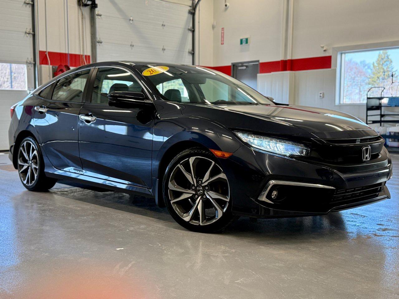 In Hondas language, Touring is top-of-the-line. Its where the Civic combines the best of performance, efficiency, and genuine luxury into one package.




This 2020 Honda Civic Touring runs an optional turbocharged engine that adds more horsepower along with improved fuel efficiency, not an easy feat. Yet the Civics fun-to-drive nature is only part of the Hondas appeal: its a very spacious and refined sedan with a long list of upmarket content, including the Honda Sensing suite of active safety tech.




Civic Touring equipment starts with leather seating and navigation and moves on to a sunroof, an 8-way power drivers seat, 10-speaker premium audio, heated front and rear seats, LED lighting, and rain-sensing wipers. Thats on top of other Civic features like a sunroof, remote start, proximity access/pushbutton start, dual-zone automatic climate control, a multi-angle rearview camera, and Apple CarPlay/Android Auto.<span class=Apple-converted-space>&nbsp;</span>




<span style=font-weight: 400;>Thank you for your interest in this vehicle. Its located at Centennial Honda, 515 Central Street, Summerside, PEI. We look forward to hearing from you; call us toll-free at 1-902-436-9158.</span>