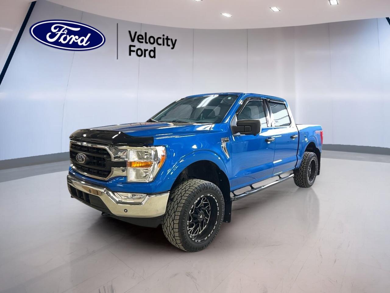 // ACCIDENT FREE!! //

This 2021 Ford F-150 XLT 4WD SuperCrew 5.5 Box at Velocity Ford in Moose Jaw is a smart full-size truck for work and daily life. CARFAX Canada reports no accident. It has a blue exterior, dark grey interior, four doors, automatic transmission, and a 2.7-litre unleaded engine.

With 168,965 km, this used Ford pickup still delivers the strong capability owners expect. The SuperCrew cab adds easy access and useful rear space, while four-wheel drive helps with rough roads, changing weather, and jobsite travel. It is built to handle busy days with confidence.

FEATURES OF THE F-150 XLT 4WD SuperCrew 5.5 Box

»» SuperCrew cab adds roomy rear access
»» 5.5-foot box supports daily hauling needs
»» Four-wheel drive adds year-round traction
»» XLT trim balances value and utility

TRUCK FEATURES

»» Towing capacity rated at 4,580 kg
»» Off-road tires support rougher terrain
»» Rear tow hook adds pulling utility
»» Rear box access helps loading tasks

ADVANCED SAFETY FEATURES

»» Backup camera helps with reversing visibility
»» Blind spot monitor boosts lane awareness
»» Lane departure warning adds extra support
»» Side and head airbags help protect

PERFORMANCE AND EFFICIENCY

»» 2.7-litre unleaded engine delivers solid power
»» Automatic transmission shifts smoothly in traffic
»» Dual shift mode adds driver control
»» Four-wheel drive improves grip on roads

COMFORT AND CONVENIENCE

»» Cruise control supports relaxed highway driving
»» Front air conditioning keeps cabin comfortable
»» Power windows add daily ease
»» Heated mirrors help in cold weather

TECHNONOLGY AND CONNECTIVITY

»» Bluetooth integration supports hands-free calling
»» WiFi hotspot keeps devices connected
»» Steering wheel audio controls add convenience
»» Automatic headlights respond in low light

CARGO SPACE

»» 5.5-foot box handles gear and supplies
»» Rear access supports easier cargo loading
»» Four-door cab helps store personal items
»» Spare tire adds practical roadside backup

AWARDS & RECOGNITIONS

»» North American Truck of the Year, North American Car, Truck and Utility Vehicle of the Year, 2021
»» Best Buy Award, The Car Guide, 2021

WHAT OTHER OWNERS LIKE

»» Strong towing and everyday hauling ability
»» Comfortable ride for a full-size truck
»» User-friendly controls and easy technology
»» Useful cabin space for family needs

This 2021 Ford F-150 XLT 4WD SuperCrew 5.5 Box is well equipped with practical features that matter every day. Highlights include power steering, Anti-Lock Braking System, stability control, child safety locks, fog lights, tinted windows, power mirrors, rear window defroster, tire pressure monitoring, and driver lumbar support.

For drivers who want proven truck strength without giving up comfort, this Ford is a great fit. It offers the space, traction, and towing ability many Moose Jaw drivers need, along with key safety and connectivity features that make each trip easier and more enjoyable.

This 2021 Ford F-150 XLT 4WD SuperCrew 5.5 Boxs VIN is: 1FTEW1EP8MFC97151.