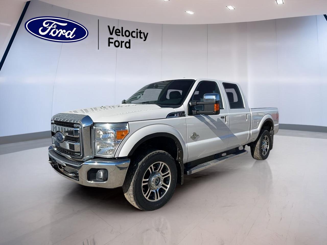 Built to handle hard work and long days, this used 2016 Ford Super Duty F-350 SRW 4WD Crew Cab 6-3/4 Ft Box Lariat delivers proven diesel strength, a roomy four-door cabin, and the comfort expected from a premium heavy-duty pickup. Finished in White with a Black interior, it pairs serious towing ability with everyday ease in Moose Jaw.

With 217,441 km on the odometer, this Ford Super Duty F-350 SRW 4WD Crew Cab 6-3/4 Ft Box Lariat offers the durability truck buyers want from a diesel platform. Its 6.7-litre diesel engine and automatic transmission support confident hauling, while four-wheel drive helps when roads, job sites, or weather conditions become more demanding.

FEATURES OF THE Super Duty F-350 SRW 4WD Crew Cab 6-3/4 Ft Box Lariat
»» Crew Cab adds spacious rear seating
»» 6.7-litre diesel delivers strong pulling power
»» Four-wheel drive supports year-round traction
»» Lariat trim adds upscale cabin comfort

TRUCK FEATURES
»» Towing capacity rated at 5,488 kg
»» Short box balances cargo and manoeuvrability
»» Rear tow hook supports demanding tasks
»» Steps help with easier cabin entry

ADVANCED SAFETY FEATURES
»» Backup camera helps with reversing visibility
»» Anti-lock braking system supports controlled stops
»» Stability control adds confidence on slippery roads
»» Side curtain airbags enhance occupant protection

PERFORMANCE AND EFFICIENCY
»» 6.7-litre diesel engine for heavy-duty work
»» Automatic transmission delivers smooth power transfer
»» Four-wheel drive improves traction in rough conditions
»» Limited slip differential boosts grip off-road

COMFORT AND CONVENIENCE
»» Heated front seats for cold mornings
»» Heated rear seats add passenger comfort
»» Dual-zone climate control manages cabin temperature
»» Memory seats simplify shared driver settings

TECHNONOLGY AND CONNECTIVITY
»» Bluetooth integration supports hands-free communication
»» Satellite radio expands entertainment choices
»» HD Radio offers clear audio reception
»» Steering wheel audio controls aid convenience

CARGO SPACE
»» 6-3/4-foot box handles useful daily loads
»» Rear trunk access helps reach stored items
»» Spare tire adds peace of mind
»» Crew Cab stores gear behind front seats

AWARDS & RECOGNITIONS
»» Best Retained Value Awards, Canadian Black Book, 2016
»» Heavy Duty Pickup Ideal Vehicle Award, AutoPacific, 2016

WHAT OTHER OWNERS LIKE
»» Strong diesel towing and hauling capability
»» Spacious Crew Cab for family use
»» Comfortable ride for a heavy-duty truck
»» Four-wheel drive confidence in winter conditions

This Ford pickup is well suited for towing, job site duty, and long highway runs. Features such as cruise control, power steering, power windows, heated mirrors, retractable mirrors, fog lights, tinted windows, adjustable pedals, automatic headlights, and automatic door locks add convenience to every trip.

Inside, the cabin is equipped for comfort and daily use. You will find front air conditioning, automatic climate control, an adjustable steering wheel, a leather steering wheel, driver lumbar support, passenger lumbar support, a power driver seat, a power passenger seat, memory mirrors, and illuminated vanity mirrors for both front occupants.

This truck also brings practical technology for modern driving. A backup camera helps when parking or lining up a trailer. Bluetooth integration supports wireless phone use, while a WiFi hotspot adds connection on the go. Tire pressure monitoring helps you stay aware of road-ready conditions during travel or work.

For buyers shopping at Velocity Ford in Moose Jaw, this used heavy-duty pickup offers the right mix of capability, comfort, and proven diesel performance. If you need a truck with strong 4WD traction, premium features, and real towing muscle, this 2016 Ford Super Duty F-350 SRW 4WD Crew Cab 6-3/4 Ft Box Lariat is ready to get to work.

This 2016 Ford Super Duty F-350 SRW 4WD Crew Cab 6-3/4 Ft Box Lariats VIN is: 1FT8W3BT3GEB81196.
