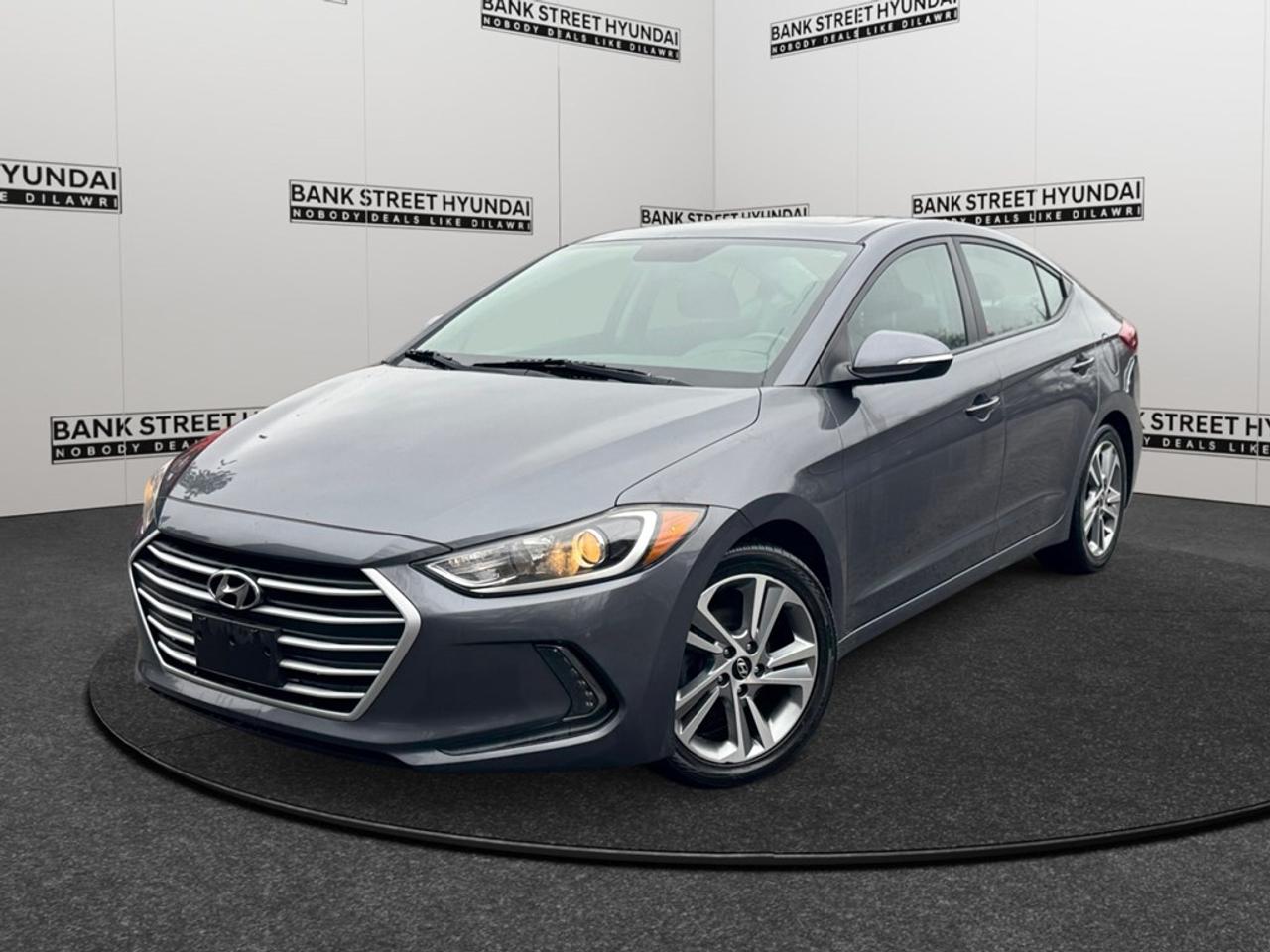 The 2017 Hyundai Elantra GLS in a stunning White finish with a Front-Wheel Drive (FWD) system offers excellent handling for city streets and highway drives. This sedan is designed to make a statement with its elegant body type and eloquent styling. Step inside to find a well-appointed interior featuring comfortable heated front and rear seats that ensure everyone travels in comfort. The leather-wrapped, heated steering wheel adds a touch of sophistication, while the leather and piano black gear shifter material emphasizes the luxury touches throughout the cabin. With keyless entry and power windows, convenience is at your fingertips. Technologically advanced, the Elantra GLS is equipped with a host of features including a backup camera for effortless parking and a comprehensive Bluetooth connection that ensures you remain connected. Stay entertained with satellite radio and smart device integration, while the sunroof invites in natural light, creating an open and airy atmosphere. Driver assistance features such as brake assist and lane assist provide confidence and peace of mind on every journey. If youre seeking a vehicle that blends style, technology, and comfort effortlessly, this Hyundai Elantra GLS could be the perfect match. Contact our dealership today to arrange a test drive or to find out more about how this outstanding sedan can elevate your driving experience.
