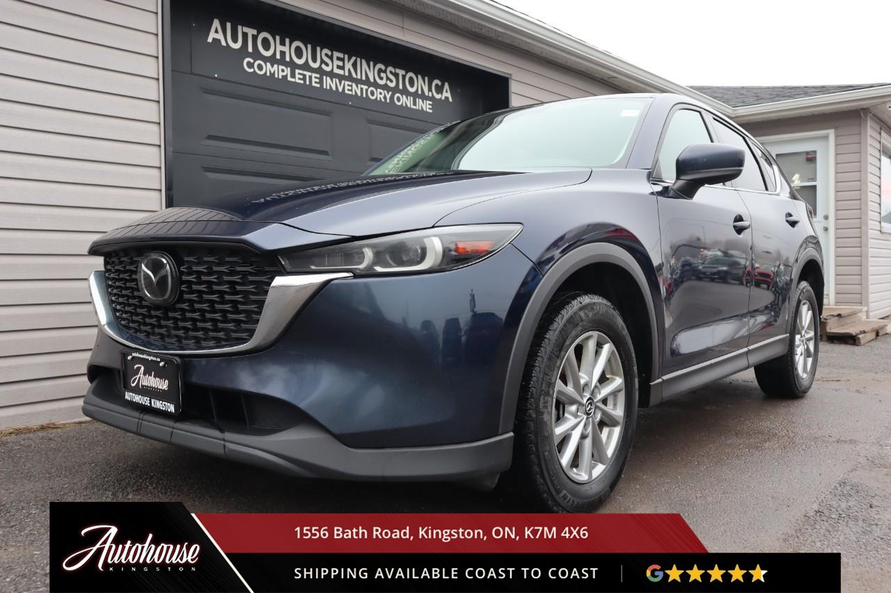 <p><strong>The 2022 Mazda CX-5 GX</strong><span style=color:rgba( 0 , 0 , 0 , 0.9 )>  Featuring a 2.5-liter Skyactiv-G inline-4 <strong>achieving an estimated 9.8 L/100km city and 7.9 L/100km highway fuel efficiency</strong>. The GX trim showcases premium cloth seating, includes heated front seats, leather-wrapped steering wheel and shift knob, dual-zone automatic climate control, and an 8.8-inch Mazda Connect infotainment display with Apple CarPlay, Android Auto, Bluetooth hands-free phone and audio streaming, and a 6-speaker audio system. i-Activsense safety technology includes Advanced Blind Spot Monitoring, Rear Cross Traffic Alert, Smart City Brake Support with pedestrian detection, Lane Departure Warning, and Rear Parking Sensors. Additional features include keyless entry with push-button start, heated power side mirrors, and so much more.</span></p>
