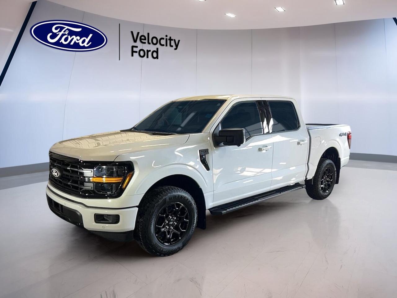 Meet the brand new 2026 Ford F-150 XLT 4WD SuperCrew 5.5 Box at Velocity Ford in Moose Jaw. This full-size truck pairs a clean White exterior with a Black interior and four full doors. It is built for hard work, family use, and everyday comfort with trusted Ford capability.

Powered by a 3.5-litre unleaded engine and automatic transmission, this 2026 Ford F-150 XLT 4WD SuperCrew 5.5 Box delivers strong performance with smooth response. Four-wheel drive adds confidence on rough roads, in winter weather, and on job sites. It is a smart fit for drivers who need real truck strength.

FEATURES OF THE F-150 XLT 4WD SuperCrew 5.5 Box

»» Four full doors for easy access
»» Short box supports daily hauling needs
»» XLT trim adds useful everyday features
»» Four-wheel drive boosts all-season traction

TRUCK FEATURES

»» Towing capacity rated at 4,671 kg
»» Rear tow hook adds utility
»» Off-road tires support tougher terrain
»» SuperCrew cab offers roomy passenger space

ADVANCED SAFETY FEATURES

»» Backup camera helps with reversing confidence
»» Blind spot monitor supports safer lane changes
»» Lane departure warning adds extra awareness
»» Side and head airbags enhance protection

PERFORMANCE AND EFFICIENCY

»» 3.5-litre unleaded engine delivers strong power
»» Automatic transmission shifts smoothly in traffic
»» Dual shift mode adds driving control
»» Four-wheel drive improves grip on surfaces

COMFORT AND CONVENIENCE

»» Cruise control supports relaxed highway travel
»» Front air conditioning keeps cabin comfortable
»» Power windows add everyday convenience
»» Driver lumbar support aids long drives

TECHNONOLGY AND CONNECTIVITY

»» Bluetooth integration supports hands-free communication
»» WiFi hotspot helps keep devices connected
»» Satellite radio expands entertainment choices
»» Steering wheel audio controls ease operation

CARGO SPACE

»» 5.5-foot box handles daily cargo tasks
»» Rear trunk access supports loading ease
»» Spacious cabin stores personal gear well
»» Spare tire adds peace of mind

WHAT OTHER OWNERS LIKE

»» Strong towing ability for work and play
»» Comfortable cabin for family and crew
»» User-friendly tech for daily driving
»» Confident four-wheel drive in all seasons

This brand new truck also includes practical details that matter every day. Heated power mirrors help in cold weather. Automatic headlights and LED headlamps improve visibility. Fog lights, tinted windows, rear window defroster, automatic door locks, and tire pressure monitoring add useful support on the road.

Inside, the layout is simple and functional, with cloth seating, an adjustable steering wheel, illuminated driver and passenger vanity mirrors, and a cabin designed for easy use. Power steering and Anti-Lock Braking System with stability control help this truck feel controlled and composed in changing conditions.

For drivers in Saskatchewan who want a dependable new pickup, this 2026 Ford F-150 XLT 4WD SuperCrew 5.5 Box offers proven capability, practical features, and everyday versatility. It is ready to tow, haul, commute, and handle demanding weather with confidence from Velocity Ford in Moose Jaw.

This 2026 Ford F-150 XLT 4WD SuperCrew 5.5 Boxs VIN is: 1FTFW3L86TKD40483.