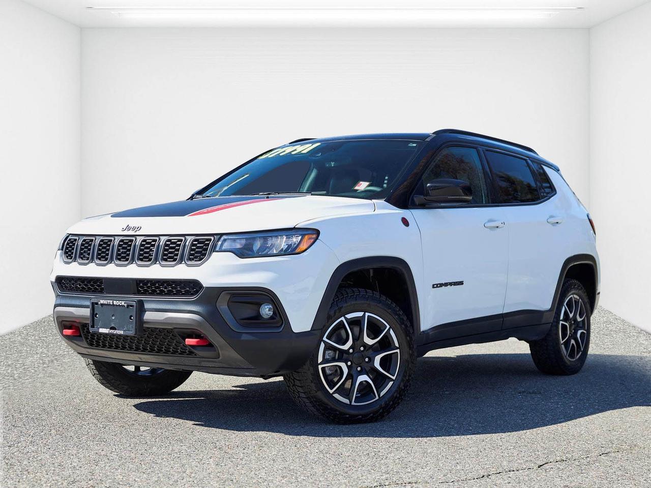 Trail Rated 4WD | Panoramic Sunroof | Navigation | Alpine Premium Audio | Heated Seats & Steering Wheel | Apple CarPlay & Android Auto | Remote Start<br /><br />2024 Jeep Compass Trailhawk 4WD<br /><br />This 2024 Jeep Compass Trailhawk 4WD in Bright White is now available at White Rock Hyundai, offering rugged capability and modern comfort in a compact SUV. Powered by a 2.0L turbocharged engine paired with an 8-speed automatic transmission and Jeeps Trail Rated 4WD system, this Compass is built to handle both city driving and off-road adventures around White Rock, Surrey, Langley, and beyond. With 69,000 km and a clean, no-accident history, this is a well-maintained and capable SUV ready for its next owner.<br /><br />As a Trailhawk model, this Compass stands out with enhanced off-road capability, including selectable terrain modes and increased ground clearance, while still delivering everyday comfort and practicality. Equipped with a premium sun and sound package, it features a panoramic sunroof, upgraded Alpine audio system, and built-in navigation, along with Apple CarPlay, Android Auto, heated seats, and a heated steering wheel. The compact size makes it easy to drive and park, while still offering versatile interior space. If you're searching for a used Jeep Compass for sale in White Rock, this Trailhawk 4WD is a unique and adventure-ready SUV.<br /><br />Why Buy From White Rock Hyundai?<br />* 7x Hyundai President's Award of Merit Winner<br />* 3x Consumer Choice Award for Business Excellence<br />* AutoTrader Dealer of the Year<br /><br />M-Promise Certified Pre-Owned ($995 value) includes:<br />* 30-day / 2,000 km Exchange Program<br />* 3-day / 300 km Money Back Guarantee<br />* Comprehensive 144-Point Mechanical Inspection<br />* Full Synthetic Oil Change<br />* BC Verified CARFAX<br />* Minimum 6 Month Powertrain Warranty<br /><br />Buy with confidence at White Rock Hyundai. Our vehicles are priced competitively based on market demand, condition, and kilometres to give our customers a transparent and hassle-free buying experience.<br /><br />Visit White Rock Hyundai today to test drive this 2024 Jeep Compass Trailhawk 4WD. We proudly serve drivers in White Rock, South Surrey, Surrey, Delta, Langley, and Vancouver with quality pre-owned vehicles and a professional, no-pressure experience.<br /><br />Contact our team today to confirm availability, explore financing options, and reserve this vehicle.<br /><br />* All vehicle purchases are subject to a $799 administration fee. Dealer #31129.