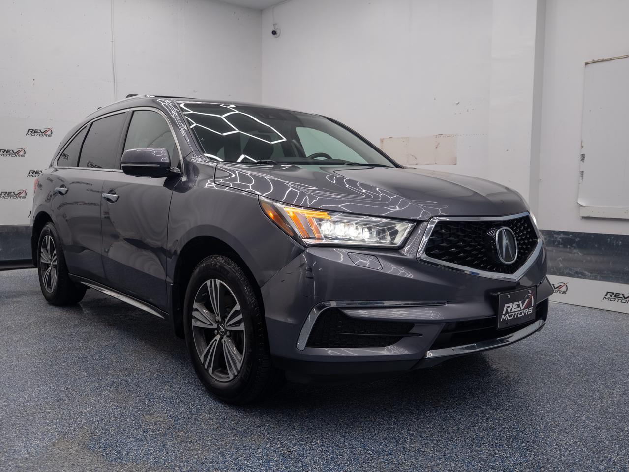 2018 Acura MDX | AWD | 7 Passenger | Sunroof | Heated Seats & Steering | Apple CarPlay<br/> <br/> Grey Exterior | Black Leather Interior | Alloy Wheels | Keyless Entry | Front Power Seats | Power Trunk | Rear Climate Control | Adaptive Cruise Control | Lane Keep Assist | Heated Steering Wheel | Voice Control | Bluetooth Connection | Front Heated Seats | Power Locks and Windows | Drivers Memory Seat With 2 Profiles | Traction Control | Sunroof | Push Button Start | Forward Collision Warning Distance | Rearview Camera and much more. <br/> <br/> <br/> Key Features: <br/> <br/> Powerful Performance <br/> Equipped with a robust 3.5L V6 engine, the MDX delivers confident acceleration and smooth handling, making it ideal for both city driving and highway cruising. <br/> <br/> <br/> Sophisticated Design <br/> The MDX showcases Acura’s signature styling with a bold front grille, Jewel Eye® LED headlights, and sculpted body lines that exude luxury and athleticism. <br/> <br/> <br/> Premium Interior <br/> Step into a spacious, upscale cabin featuring high-quality materials, leather-trimmed seating, tri-zone climate control, and versatile cargo space for all your adventures. <br/> <br/> <br/> Smart Technology <br/> Stay connected with Acura’s intuitive infotainment system, offering Bluetooth connectivity, voice recognition, and available navigation—all accessible via dual-screen displays. <br/> <br/> <br/> Advanced Safety <br/> Drive with peace of mind thanks to a suite of safety features including Collision Mitigation Braking, Lane Keeping Assist, Adaptive Cruise Control, and a multi-angle rearview camera. <br/> <br/> <br/> This vehicle has travelled 152,072 Kms. <br/> <br/> <br/> *** NO additional fees except for taxes and licensing! *** <br/> <br/> <br/> *** 100-point inspection on all our vehicles & always detailed inside and out *** <br/> <br/> <br/> RevMotors is at your service to ensure you find the right car for YOU. Even if we do not have it in our inventory, we are more than happy to find you the vehicle that you are looking for. Give us a call at 613-791-3000 or visit us online at www.revmotors.ca <br/> <br/> <br/> Ça nous donnera du plaisir de vous servir en Français aussi! <br/> <br/> <br/> CERTIFICATION * All our vehicles are sold Certified for the province of Ontario (Quebec Safety Available, additional charges may apply) <br/> FINANCING AVAILABLE * RevMotors offers competitive finance rates through many of the major banks. Should you feel like youve had credit issues in the past, we have various financing solutions to get you on the road. We accept No Credit - New Credit - Bad Credit - Bankruptcy - Students and more!! <br/> EXTENDED WARRANTY * For your peace of mind, if one of our used vehicles is no longer covered under the manufacturer’s warranty, RevMotors will provide you with a 6 month / 6000KMS Limited Powertrain Warranty. You always have the options to upgrade to more comprehensive coverage as well. Well be more than happy to review the options and chose the coverage thats right for you! <br/> TRADES * Do you have a Trade-in? We offer competitive trade in offers for your current vehicle! <br/> SHIPPING * We can ship anywhere across Canada. Give us a call for a quote and we will be happy to help! <br/> <br/> <br/> Buy with confidence knowing that we always have your best interests in mind! <br/>