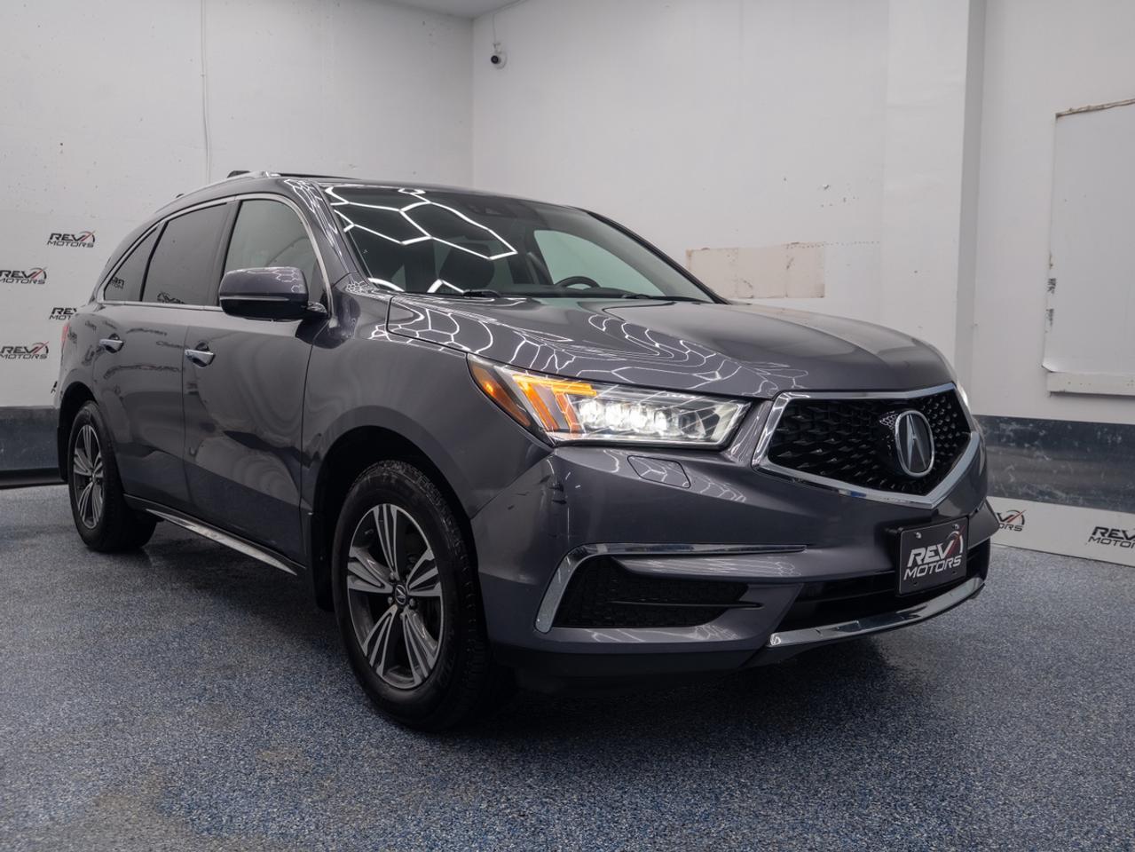 2018 Acura MDX | AWD | 7 Passenger | Sunroof | Heated Seats & Steering | Apple CarPlay<br/> <br/> Grey Exterior | Black Leather Interior | Alloy Wheels | Keyless Entry | Front Power Seats | Power Trunk | Rear Climate Control | Adaptive Cruise Control | Lane Keep Assist | Heated Steering Wheel | Voice Control | Bluetooth Connection | Front Heated Seats | Power Locks and Windows | Drivers Memory Seat With 2 Profiles | Traction Control | Sunroof | Push Button Start | Forward Collision Warning Distance | Rearview Camera and much more. <br/> <br/> <br/> Key Features: <br/> <br/> Powerful Performance <br/> Equipped with a robust 3.5L V6 engine, the MDX delivers confident acceleration and smooth handling, making it ideal for both city driving and highway cruising. <br/> <br/> <br/> Sophisticated Design <br/> The MDX showcases Acura’s signature styling with a bold front grille, Jewel Eye® LED headlights, and sculpted body lines that exude luxury and athleticism. <br/> <br/> <br/> Premium Interior <br/> Step into a spacious, upscale cabin featuring high-quality materials, leather-trimmed seating, tri-zone climate control, and versatile cargo space for all your adventures. <br/> <br/> <br/> Smart Technology <br/> Stay connected with Acura’s intuitive infotainment system, offering Bluetooth connectivity, voice recognition, and available navigation—all accessible via dual-screen displays. <br/> <br/> <br/> Advanced Safety <br/> Drive with peace of mind thanks to a suite of safety features including Collision Mitigation Braking, Lane Keeping Assist, Adaptive Cruise Control, and a multi-angle rearview camera. <br/> <br/> <br/> This vehicle has travelled 152,072 Kms. <br/> <br/> <br/> *** NO additional fees except for taxes and licensing! *** <br/> <br/> <br/> *** 100-point inspection on all our vehicles & always detailed inside and out *** <br/> <br/> <br/> RevMotors is at your service to ensure you find the right car for YOU. Even if we do not have it in our inventory, we are more than happy to find you the vehicle that you are looking for. Give us a call at 613-791-3000 or visit us online at www.revmotors.ca <br/> <br/> <br/> Ça nous donnera du plaisir de vous servir en Français aussi! <br/> <br/> <br/> CERTIFICATION *This vehicle is sold Certified for the province of Ontario (Quebec Safety Available, additional charges may apply) <br/> FINANCING AVAILABLE * RevMotors offers competitive finance rates through many of the major banks. Should you feel like youve had credit issues in the past, we have various financing solutions to get you on the road. We accept No Credit - New Credit - Bad Credit - Bankruptcy - Students and more!! <br/> EXTENDED WARRANTY * For your peace of mind, if one of our used vehicles is no longer covered under the manufacturer’s warranty, RevMotors will provide you with a 6 month / 6000KMS Limited Powertrain Warranty. You always have the options to upgrade to more comprehensive coverage as well. Well be more than happy to review the options and chose the coverage thats right for you! <br/> TRADES * Do you have a Trade-in? We offer competitive trade in offers for your current vehicle! <br/> SHIPPING * We can ship anywhere across Canada. Give us a call for a quote and we will be happy to help! <br/> <br/> <br/> Buy with confidence knowing that we always have your best interests in mind! <br/>