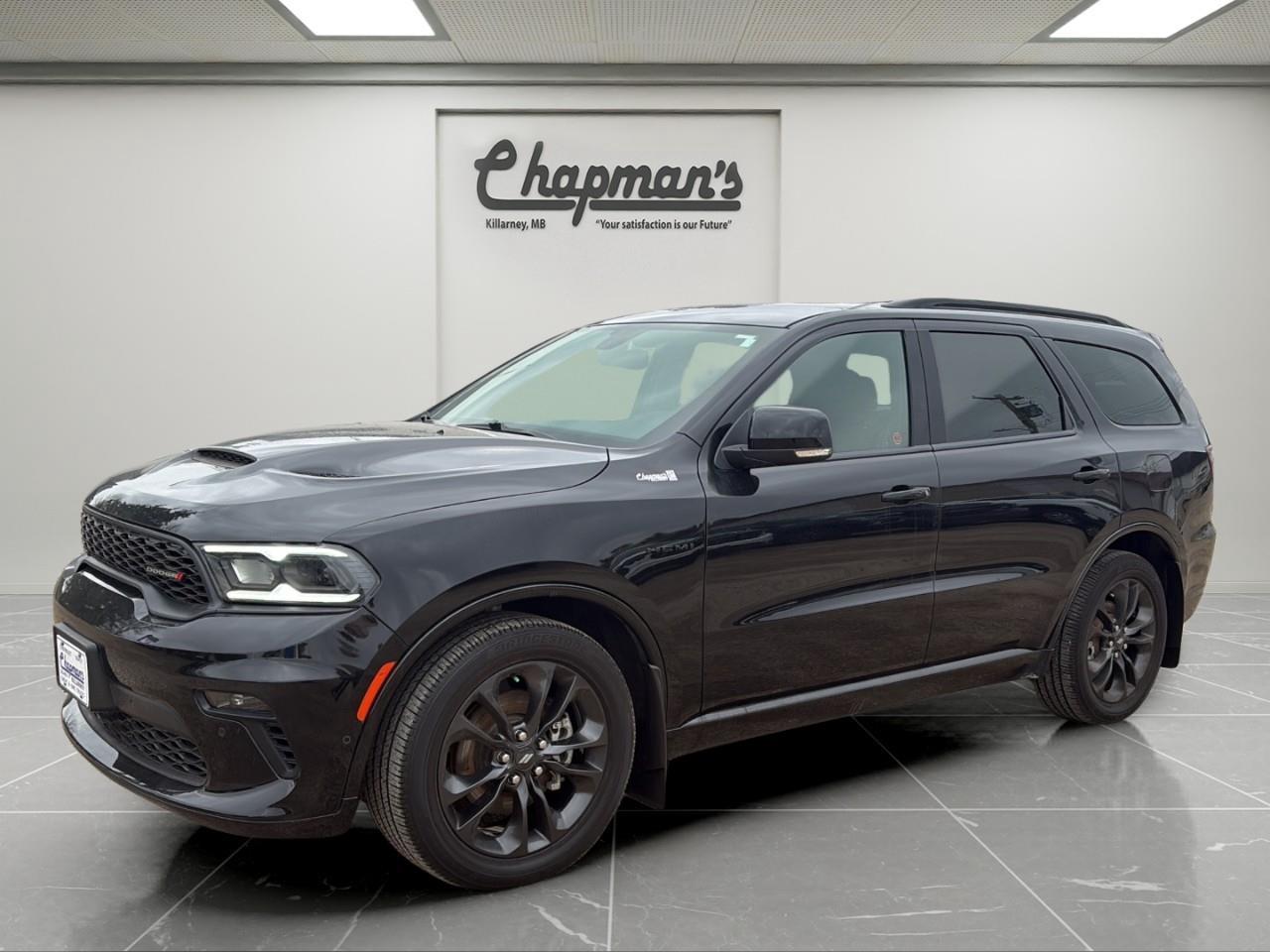 <p>Finished in DB Black with a Black interior, this 2022 Dodge Durango R/T AWD is a performance-focused SUV that blends muscle car attitude with family-ready practicality. With its bold styling, three-row seating, and R/T trim, it delivers both everyday usability and aggressive performance.</p><p>Powered by a 5.7L HEMI V8 engine paired with an 8-speed automatic transmission, this Durango delivers strong horsepower and towing capability. With all-wheel drive and a performance-tuned setup, it offers confident handling and year-round traction.</p><h3>Performance & Capability</h3><ul><li><p>5.7L HEMI V8 engine</p></li><li><p>8-speed automatic transmission</p></li><li><p>All-wheel drive (AWD)</p></li><li><p>2-speed on-demand transfer case</p></li><li><p>Trailer Tow Group IV with trailer brake control</p></li><li><p>Performance-tuned suspension</p></li><li><p>Electronic stability control and traction control</p></li></ul><h3>Interior Comfort & Convenience</h3><ul><li><p>Napa leather-faced bucket seats</p></li><li><p>Heated and ventilated front seats</p></li><li><p>Heated second-row seats</p></li><li><p>Power sunroof</p></li><li><p>Tri-zone automatic climate control</p></li><li><p>Power liftgate</p></li><li><p>Remote start system</p></li><li><p>6-passenger seating with second-row captains chairs</p></li></ul><h3>Technology & Connectivity</h3><ul><li><p>Uconnect 5 NAV with 10.1" touchscreen</p></li><li><p>Apple CarPlay & Android Auto</p></li><li><p>SiriusXM with 360L</p></li><li><p>Premium audio system</p></li><li><p>Wireless charging pad</p></li><li><p>Bluetooth hands-free communication</p></li></ul><h3>Safety & Driver Assistance</h3><ul><li><p>Blind spot monitoring with rear cross-path detection</p></li><li><p>ParkSense front and rear park assist with stop</p></li><li><p>ParkView rear back-up camera</p></li><li><p>Advanced multistage airbags</p></li><li><p>Electronic stability control</p></li><li><p>Hill start assist</p></li></ul><h3>Exterior Highlights</h3><ul><li><p>DB Black exterior finish</p></li><li><p>20" Black Noise aluminum wheels</p></li><li><p>Blacktop Package with blacked-out accents</p></li><li><p>LED headlamps and taillamps</p></li><li><p>Power liftgate</p></li><li><p>Roof rails with integrated crossbars</p></li><li><p>Performance hood styling</p></li></ul><p>A powerful V8 SUV that delivers bold styling, strong towing capability, and premium comfort for drivers who want performance without sacrificing space.</p><p>Price Includes Dealer Fee.</p><p>Price Excludes PST & GST.</p><p>Financing Options Available, Call For More Details.</p> <p><strong>*While every reasonable effort is made to ensure the accuracy of this information, we are not responsible for any error or omissions contained on these pages. Please verify any information in question with Chapman Motors Ltd.</strong></p>