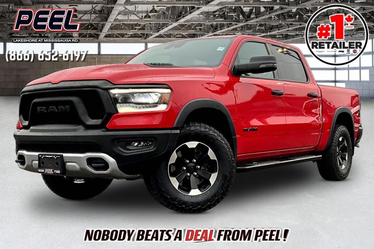 COME SEE WHY NOBODY BEATS A DEAL FROM PEEL! Your Source for ALL make and models used cars and trucks. The True #1 Stellantis Retailer in Ontario for 14 years and running!! (*)

2023 Ram 1500 Rebel Crew Cab 4X4 | 5.7L V8 w/ eTorque | Flame Red | Heated Vinyl/Cloth Bucket Seats | Uconnect 12" Touchscreen Display w/ Navigation | 9-speaker Alpine Premium Audio System | Wireless Apple CarPlay & Android Auto | Heated Steering Wheel | Forward Collision Warning | Rear Power Sliding Window | Class IV Hitch Receiver | 3.92 Rear Axle Ratio | Bed Utility Group | Deployable Bed Step | Mopar Black Side Steps

One Owner Clean Carfax

Bold in Flame Red and built to do more than just look the part, this 2023 Ram 1500 Rebel Crew Cab 4X4 brings the proven 5.7L HEMI V8 with 395 hp and 410 lb-ft of torque, giving you that instant throttle response and confident pulling power whether you are towing, merging, or heading off the pavement. Inside, it strikes the right balance of durability and comfort with heated vinyl and cloth bucket seats, a heated steering wheel, a rear power sliding window, and the massive 12-inch Uconnect touchscreen with navigation, wireless Apple CarPlay and Android Auto, plus a 9-speaker Alpine system that adds a premium feel to every drive. Forward Collision Warning adds an extra layer of confidence in traffic and on longer highway runs. On the functional side, this Rebel is properly equipped with a Class IV hitch, 3.92 rear axle ratio for stronger off-the-line pull, and the Bed Utility Group with a deployable bed step to make loading and towing easier, while Mopar black side steps add both style and practicality. With One Owner and Clean Carfax history, this is the kind of Rebel buyers look for, strong V8 performance, the right options, and a bold spec that stands out on the road and holds its value.
______________________________________________________

Engage & Explore with Peel Chrysler: Whether youre inquiring about our latest offers or seeking guidance, 1-866-652-6197 connects you directly. Dive deeper online or connect with our team to navigate your automotive journey seamlessly.

WE TAKE ALL TRADES & CREDIT. WE SHIP ANYWHERE IN CANADA! OUR TEAM IS READY TO SERVE YOU 7 DAYS!
______________________________________________________
Our advertised prices are for consumers (i.e end users) only. 

*FREE CarFax (click the link above to check it out at no cost to you!)*

*FULLY CERTIFIED! (Have you seen some of these other dealers stating in their advertisements that certification is an additional fee? NOT HERE! Our certification is already included in our low sale prices to save you more!)

(*) Based on the Eastern Business Center National Ranking reported sales to actual customers, not including demonstrators.
______________________________________________________

Peel Chrysler  A Trusted Destination: Based in Port Credit, Ontario, we proudly serve customers from all corners of Ontario and Canada including Toronto, Oakville, North York, Richmond Hill, Ajax, Hamilton, Niagara Falls, Brampton, Thornhill, Scarborough, Vaughan, London, Windsor, Cambridge, Kitchener, Waterloo, Brantford, Sarnia, Pickering, Huntsville, Milton, Woodbridge, Maple, Aurora, Newmarket, Orangeville, Georgetown, Stouffville, Markham, North Bay, Sudbury, Barrie, Sault Ste. Marie, Parry Sound, Bracebridge, Gravenhurst, Oshawa, Ajax, Kingston, Innisfil and surrounding areas. On our website www.peelchrysler.com, you will find a vast selection of new vehicles including the new and used Ram 1500, 2500 and 3500. Chrysler Grand Caravan, Chrysler Pacifica, Jeep Cherokee, Wrangler and more. All vehicles are priced to sell. We deliver throughout Canada. website or call us 1-866-652-6197. 

Disclaimer Statement: At Peel Chrysler, your satisfaction is our priority. While many pre-owned vehicles originally come with two keys, variations may occur based on trade-ins, and all Peel Chrysler Pre-Owned Vehicles come standard with one key. Any extras provided by the previous owner will be included with your purchase, and additional keys can be bought at the time of sale. Online prices and payments are for finance purchases. Used vehicles that are being financed are subject to a $499 (^$1500 non-prime) financing fee, while cash purchases (certified cheque, bank draft, or wire transfer) on used vehicles have a $2,000 surcharge ( online price + $2,000). Cash purchases of new vehicles only incur applicable taxes and licensing fees, and those priced above $100,000 (including accessories or add-ons) are subject to a federal luxury tax. Optional finance and lease terms are available, and if trading in a vehicle with an outstanding loan balance requiring Peel Chrysler to facilitate the lien payout, a Lien Payout Fee of $349 applies. Prices, rates, and payments are subject to change without notice. While we strive for accuracy, occasional technical or human errors may occur, so we encourage verifying all vehicle details, including features, options, materials, and specifications, with a Peel Chrysler representative by contacting us or visiting our dealership. Experience seamless convenience with our nationwide delivery options. Visit our website or contact us for more details.