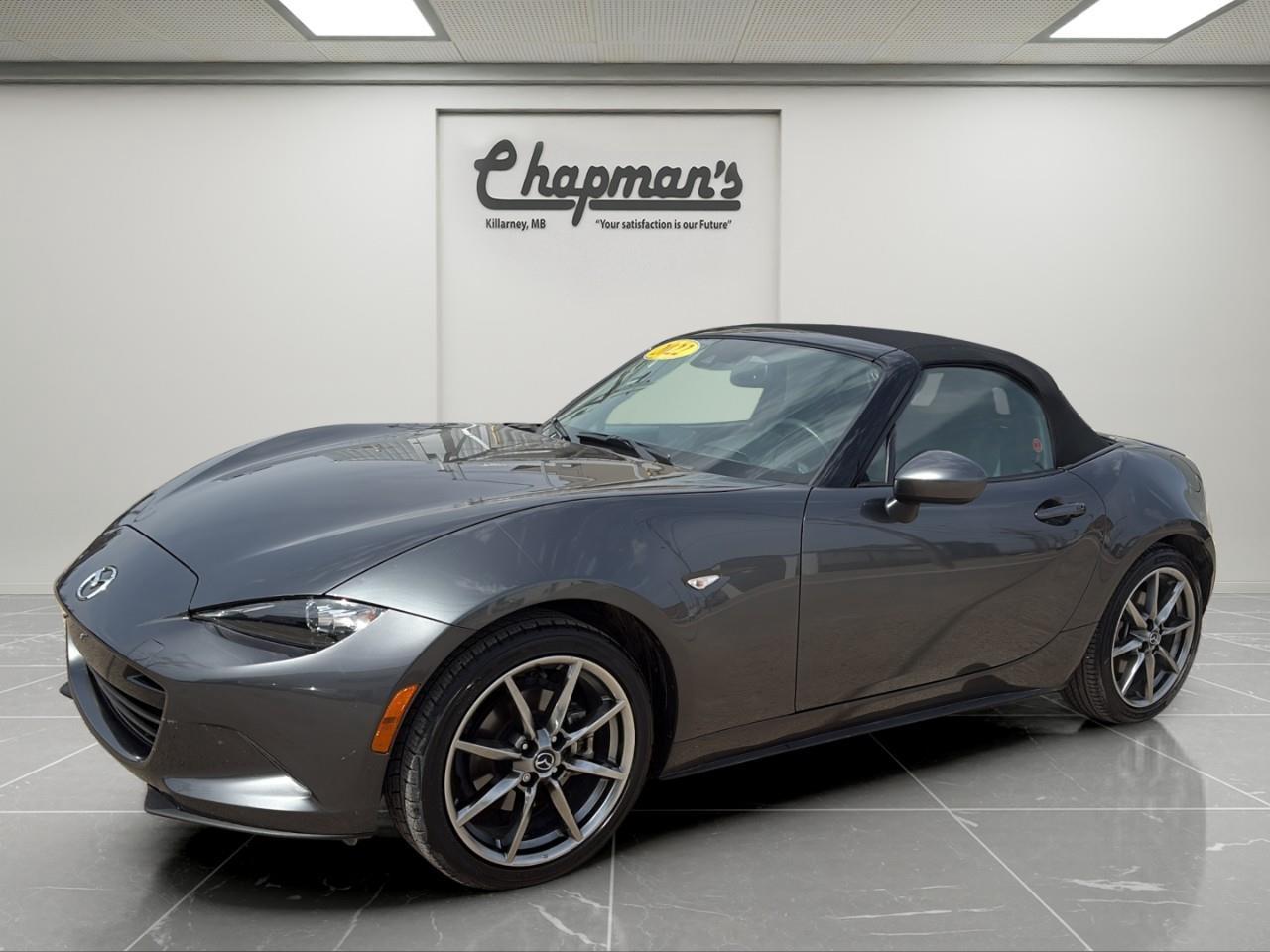 <p>Finished in a sleek exterior with a refined interior, this 2022 Mazda MX-5 GT is a lightweight roadster built for pure driving enjoyment. With its iconic rear-wheel drive layout, responsive handling, and convertible design, it delivers a true sports car experience every time you get behind the wheel.</p><p>Powered by a SKYACTIV-G 2.0L 4-cylinder engine, this MX-5 delivers lively performance and precise control. Paired with a sport-tuned chassis and rear-wheel drive, it offers sharp handling, balanced cornering, and an engaging open-air driving experience.</p><h3>Performance & Capability</h3><ul><li><p>SKYACTIV-G 2.0L 4-cylinder engine</p></li><li><p>Rear-wheel drive (RWD)</p></li><li><p>Sport-tuned suspension</p></li><li><p>Double wishbone front suspension</p></li><li><p>Multi-link rear suspension</p></li><li><p>Electric power steering</p></li><li><p>Engine oil cooler</p></li><li><p>High-performance summer tires</p></li></ul><h3>Interior Comfort & Convenience</h3><ul><li><p>Heated sport seats with 3 heat settings</p></li><li><p>Leather-wrapped steering wheel and shifter</p></li><li><p>Automatic climate control</p></li><li><p>Manual tilt and telescoping steering wheel</p></li><li><p>Auto-dimming rearview mirror</p></li><li><p>HomeLink garage door transmitter</p></li><li><p>Convertible soft top with wind blocker</p></li></ul><h3>Technology & Connectivity</h3><ul><li><p>Driver information centre</p></li><li><p>Steering wheel-mounted cruise controls</p></li><li><p>Bluetooth connectivity</p></li><li><p>12V power outlet</p></li><li><p>Keyless entry and push-button start</p></li></ul><h3>Safety & Driver Assistance</h3><ul><li><p>Blind Spot Monitoring</p></li><li><p>Rear Cross Traffic Alert</p></li><li><p>Smart City Brake Support</p></li><li><p>Lane Departure Warning System</p></li><li><p>Rearview camera</p></li><li><p>Adaptive LED headlights with auto high beams</p></li><li><p>Electronic brake assist and hill hold control</p></li></ul><h3>Exterior Highlights</h3><ul><li><p>17" dark silver aluminum alloy wheels</p></li><li><p>LED headlights and taillights</p></li><li><p>Heated power side mirrors</p></li><li><p>Rain-sensing wipers</p></li><li><p>Manual convertible soft top</p></li><li><p>Adaptive front lighting system</p></li></ul><p>A lightweight rear-wheel drive roadster that combines sharp handling, open-air driving, and modern safety technology for an unforgettable driving experience.</p><p>Price Includes Dealer Fee.</p><p>Price Excludes PST & GST.</p><p>Financing Options Available, Call For More Details.</p> <p><strong>*While every reasonable effort is made to ensure the accuracy of this information, we are not responsible for any error or omissions contained on these pages. Please verify any information in question with Chapman Motors Ltd.</strong></p>