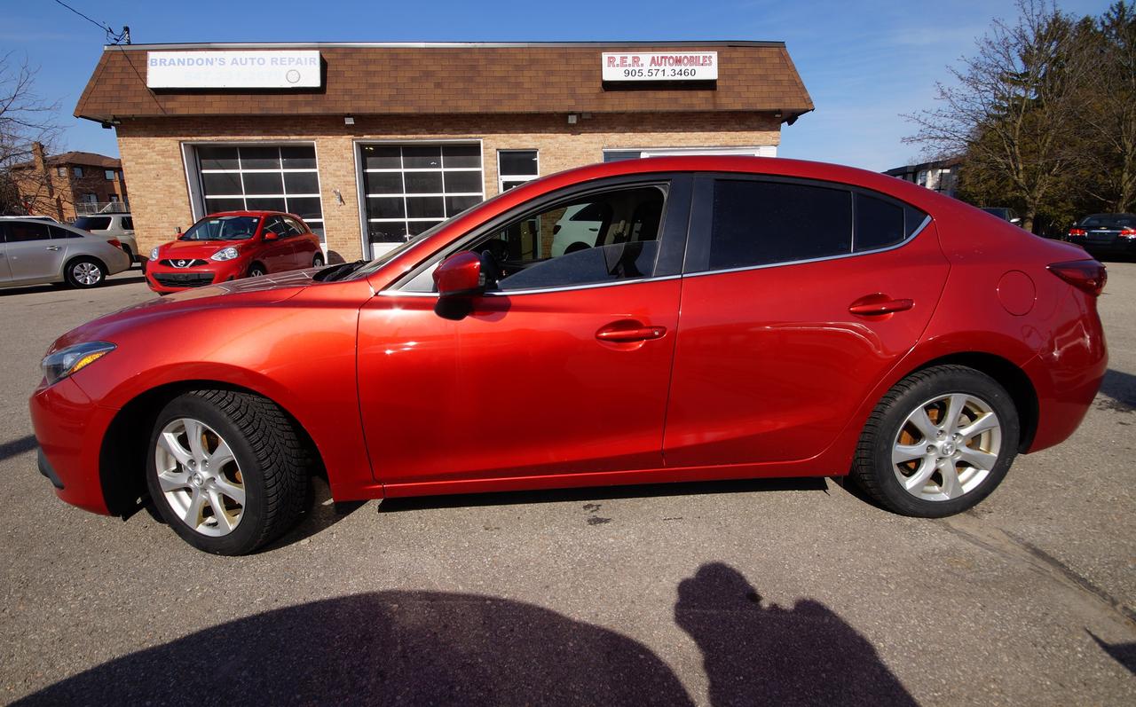 <p>Cruise the streets in style with this head-turning 2015 Mazda MAZDA3 GS, available now at R.E.R. Automobiles Ltd! This sleek sedan boasts a vibrant red exterior, perfectly complemented by a sophisticated black interior. With just 126,338km on the odometer, this fuel-efficient and reliable Mazda3 is ready to provide you with years of comfortable driving. Its automatic transmission and front-wheel drive make for an effortless and enjoyable ride, whether youre navigating city streets or embarking on a weekend getaway.</p><p>Inside, youll discover a thoughtfully designed cabin packed with features. Enjoy the convenience of a modern and practical vehicle, perfectly suited for both daily commutes and longer journeys. The 2015 Mazda3 GS offers a fantastic blend of sporty performance and everyday practicality, making it a great choice for a wide variety of drivers.</p><p>Here are some of the standout features of this Mazda MAZDA3 GS:</p><ul><li><strong>Sporty Handling:</strong> Experience responsive steering and confident handling, making every drive a pleasure.</li><li><strong>Fuel Efficiency:</strong> Save money at the pump with its impressive fuel economy.</li><li><strong>Stylish Design:</strong> Turn heads with its eye-catching red exterior and modern sedan lines.</li><li><strong>Comfortable Interior:</strong> Relax and enjoy the ride in a well-appointed cabin designed for comfort.</li><li><strong>Automatic Transmission:</strong> Enjoy smooth and easy driving with the convenience of an automatic transmission.</li></ul><p><strong><em>Powered by AutoIntelligence&trade;</em></strong> Vehicle information has been generated using artificial intelligence and is provided for informational purposes only. While efforts are made to ensure accuracy, please confirm all details directly with the dealer.</p>