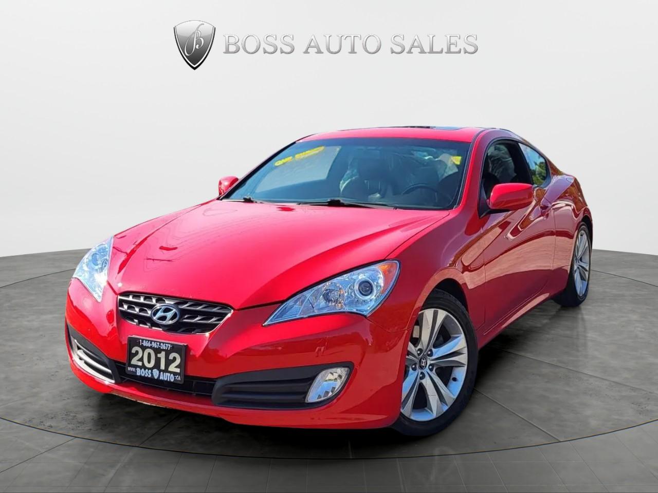 <p>The 2012 Hyundai Genesis Coupe Premium in its vibrant red hue and rear-wheel-drive configuration offers an exhilarating driving experience, making it perfect for enthusiasts who appreciate precision handling and a sporty feel. Powered by a robust 2.0L 4-cylinder engine paired with an automatic transmission, it ensures smooth yet spirited performance.</p><p>Admire the striking exterior, equipped with alloy wheels and a practical sunroof/moonroof, highlighting this coupes stylish silhouette. Inside, indulge in the comfort of the luxurious black leather seats and a leather-wrapped steering wheel. The interior is further enhanced by premium features such as heated front seats and a sophisticated leather shift knob, complementing the overall aesthetic.</p><p>Stay connected and entertained with Bluetooth connectivity and satellite radio&mdash;all controlled effortlessly from within the driver-centric cabin. Safety is paramount with features like brake assist and heated mirrors, providing added confidence on every journey. The car also includes a keyless entry system and convenient power windows for everyday ease.</p><p>This is an ideal vehicle for those who value performance and style alongside comfort and technology. Don&rsquo;t miss your chance to own this dynamic and engaging coupe. Reach out to our dealership today to learn more about this 2012 Hyundai Genesis Coupe Premium!</p>