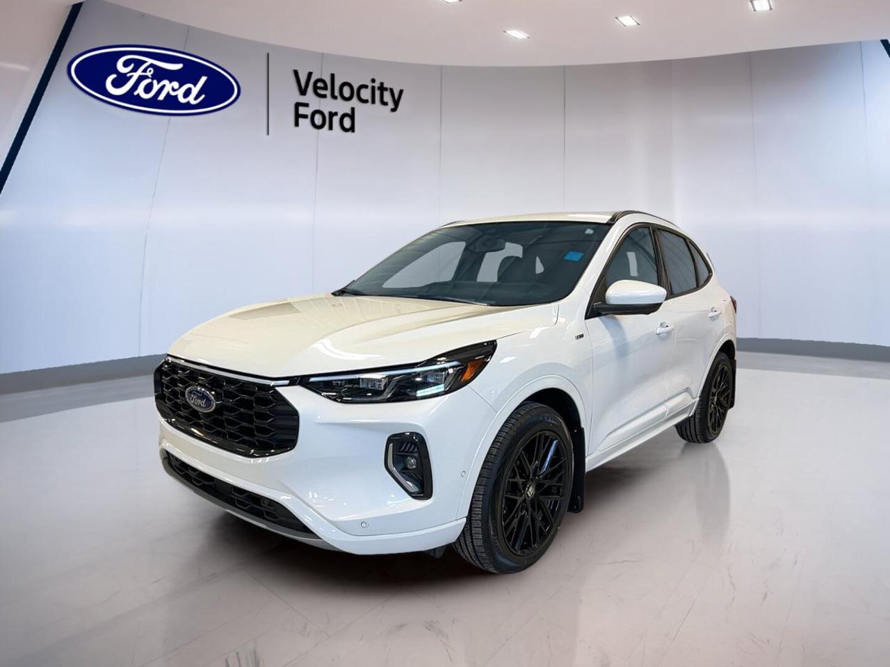 This used 2023 Ford Escape ST-Line Elite AWD at Velocity Ford in Moose Jaw brings together sporty style, smart utility, and confident all-wheel-drive capability. Finished in Grey with a Black interior, this four-door SUV has 63,222 km and a 2.0-litre unleaded engine with automatic transmission for smooth daily driving.

The 2023 Ford Escape ST-Line Elite AWD is a great fit for drivers who want comfort, modern tech, and useful safety features in one practical package. Its sleek profile, rear spoiler, LED headlamps, and tinted windows give it a clean, athletic look, while the cabin focuses on ease of use and everyday comfort.

FEATURES OF THE Escape ST-Line Elite AWD

»» Grey exterior with sporty ST-Line styling
»» All-wheel drive for added traction
»» 2.0-litre unleaded engine performance
»» Power liftgate adds everyday convenience

ADVANCED SAFETY FEATURES

»» Backup camera helps with safer reversing
»» Blind spot monitor boosts lane awareness
»» Lane departure warning supports safer travel
»» Side and head airbags add protection

PERFORMANCE AND EFFICIENCY

»» 2.0-litre engine delivers smooth responsive power
»» Automatic transmission supports easy daily driving
»» All-wheel drive adds year-round confidence
»» Stability control helps maintain road composure

COMFORT AND CONVENIENCE

»» Heated front seats for cold mornings
»» Dual-zone climate control improves cabin comfort
»» Remote starter adds everyday convenience
»» Power liftgate simplifies cargo access

TECHNONOLGY AND CONNECTIVITY

»» Navigation system helps guide every trip
»» Bluetooth integration supports hands-free communication
»» WiFi hotspot keeps passengers connected
»» Steering wheel audio controls ease access

CARGO SPACE

»» Rear trunk access makes loading simple
»» Four-door layout improves daily practicality
»» Flexible cargo area suits busy lifestyles
»» Spare tire adds peace of mind

AWARDS & RECOGNITIONS

»» Top Safety Pick, Insurance Institute for Highway Safety, 2023

WHAT OTHER OWNERS LIKE

»» Comfortable ride quality for everyday travel
»» User-friendly technology and clear controls
»» Confident all-wheel-drive traction year-round
»» Practical cargo room for active lifestyles

This 2023 Ford Escape ST-Line Elite AWD also includes many sought-after features that add value to every drive. Highlights include cruise control, power steering, Anti-Lock Braking System, stability control, child safety locks, automatic headlights, fog lights, tire pressure monitoring, and heated mirrors.

Inside, this 2023 Ford Escape ST-Line Elite AWD offers thoughtful convenience with power windows, electric mirrors, memory mirrors, memory seats, a power driver seat, power passenger seat, lumbar support for the driver, push-button start, automatic door locks, rear window defroster, and illuminated vanity mirrors for both front passengers.

Entertainment and information features in this 2023 Ford Escape ST-Line Elite AWD help keep every drive more enjoyable. Satellite radio, Bluetooth integration, navigation, and steering wheel audio controls all work together to create an easy and connected experience for commuting, errands, and road trips around Saskatchewan.

This SUV also supports peace of mind with driver and passenger airbags, passenger airbag sensor, side impact airbags, head side airbags, ABS, and a backup camera. Combined with blind spot monitoring and lane departure warning, these features help make the 2023 Ford Escape ST-Line Elite AWD a smart choice for family use.

With its balance of style, comfort, useful equipment, and capable all-wheel-drive performance, this used 2023 Ford Escape ST-Line Elite AWD stands out as a versatile SUV for life in Moose Jaw. It is well equipped for changing weather, daily errands, highway travel, and weekend plans alike.

This 2023 Ford Escape ST-Line Elite AWDs VIN is: 1FMCU9PA9PUA30083 .