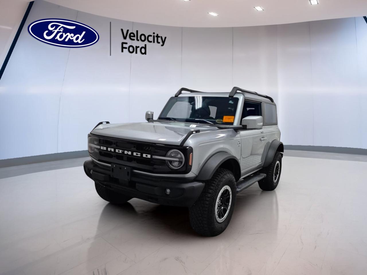 // ACCIDENT FREE!! //
// SINGLE OWNER! //

This 2023 Ford Bronco Outer Banks 2 Door Advanced 4x4 COMING SOON is ready for drivers who want open-air freedom, real 4x4 ability, and modern comfort. Sold by Velocity Ford in Moose Jaw, it has had one owner and CARFAX Canada reports no accidents for added peace of mind.

Finished in Silver with a Black interior, this used SUV has a bold, clean look and a purpose-built design. With 17,454 km, an automatic transmission, and a 2.7-litre unleaded engine, this Bronco Outer Banks 2 Door Advanced 4x4 COMING SOON delivers strong power and confident everyday usability.

Built for Canadian roads and changing weather, this two-door Ford pairs rugged capability with easy-to-use features. The removable hardtop adds fresh-air fun, while heated front seats, dual-zone climate control, navigation, and a backup camera help make every trip more enjoyable.

FEATURES OF THE Bronco Outer Banks 2 Door Advanced 4x4 COMING SOON

»» 2.7-litre engine with automatic transmission
»» Advanced 4x4 system for added capability
»» Convertible hardtop for open-air driving
»» Off-road tires for rugged traction

ADVANCED SAFETY FEATURES

»» Backup camera helps with reversing visibility
»» Blind spot monitor adds lane awareness
»» Lane departure warning supports safer travel
»» Side and head airbags enhance protection

PERFORMANCE AND EFFICIENCY

»» 2.7-litre unleaded engine delivers strong power
»» Automatic transmission shifts smoothly and quickly
»» Four-wheel drive supports all-season confidence
»» Limited slip differential aids traction control

COMFORT AND CONVENIENCE

»» Heated front seats add cold-weather comfort
»» Dual-zone climate control keeps cabin balanced
»» Remote starter helps on chilly mornings
»» Power windows and locks add ease

TECHNONOLGY AND CONNECTIVITY

»» Navigation system helps guide each trip
»» Bluetooth integration supports hands-free connection
»» WiFi hotspot keeps devices connected
»» Steering wheel audio controls simplify access

CARGO SPACE

»» Rear trunk access makes loading easier
»» Two-door layout keeps gear close by
»» Spare tire adds travel peace
»» Flexible cargo area suits daily needs

AWARDS & RECOGNITIONS

»» North American Utility Vehicle finalist, North American Car Awards, 2021
»» Best 4x4 and Pickup, The Car Guide, 2023

WHAT OTHER OWNERS LIKE

»» Strong off-road ability in varied conditions
»» Easy removable roof for open-air fun
»» Powerful engine with smooth automatic shifting
»» Modern tech mixed with classic Bronco character

This Ford also includes cruise control, power steering, anti-lock braking system, stability control, automatic headlights, fog lights, LED headlamps, tinted windows, heated mirrors, electric mirrors, rear window defroster, push button start, satellite radio, and an auto-dimming rearview mirror.

Driver-focused details help this SUV feel easy to live with every day. You also get front air conditioning, automatic climate control, illuminated vanity mirrors, tire pressure monitoring, passenger airbag sensor, rear tow hook, and a leather-wrapped steering wheel for a refined touch.

If you want a capable SUV with true Ford character, low kilometres, and the confidence of a clean CARFAX Canada report, this 2023 Ford Bronco Outer Banks 2 Door Advanced 4x4 COMING SOON is a smart choice at Velocity Ford in Moose Jaw.

This 2023 Ford Bronco Outer Banks 2 Door Advanced 4x4 COMING SOONs VIN is: 1FMDE5CP0PLB04128.