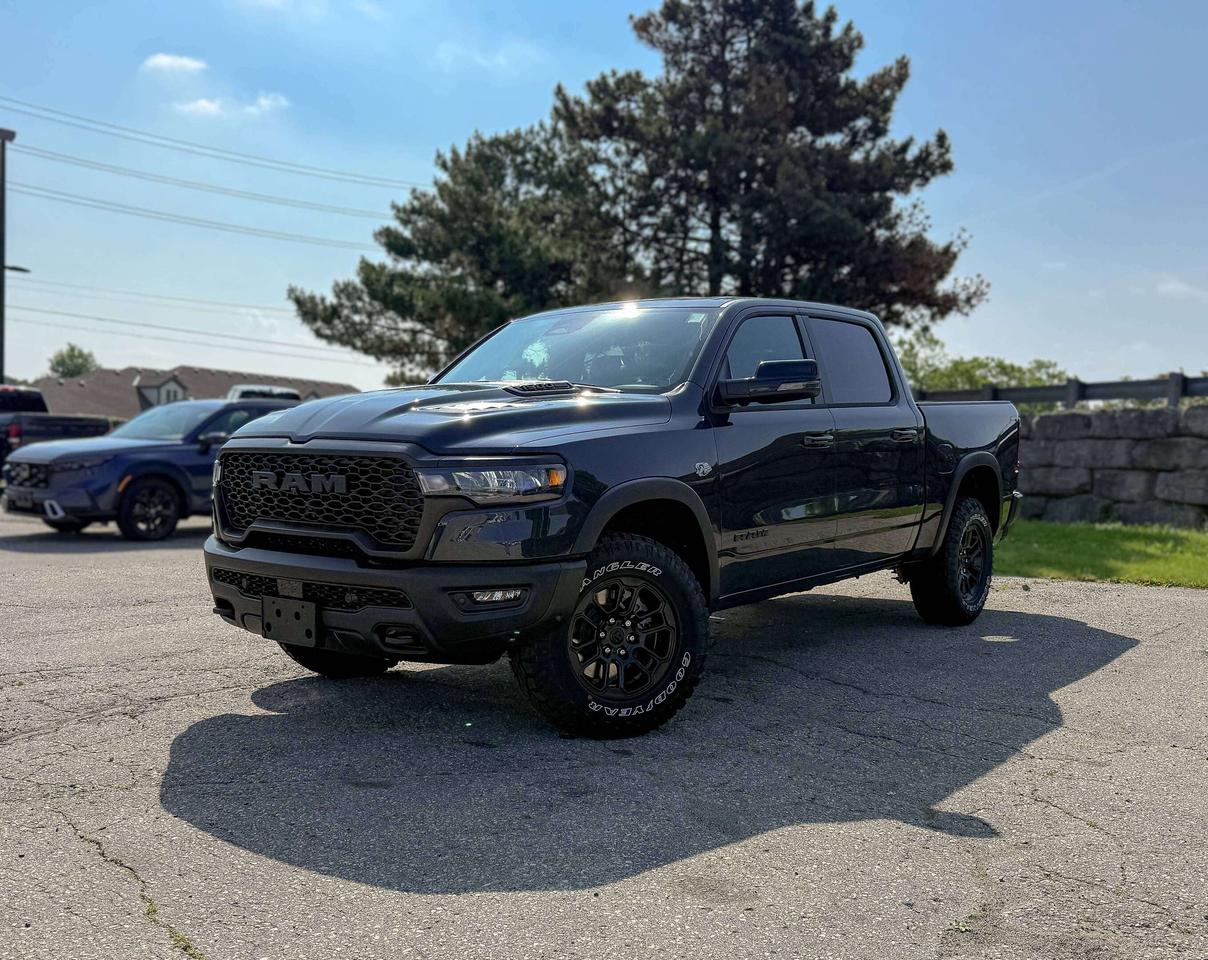 Bold and unmistakable, our New 2026 RAM 1500 Rebel Crew Cab 4X4 in Forged Blue Metallic stands out with aggressive design and off-road capability. Powered by a 5.7 Litre HEMI eTorque V8 and a 48V Mild-Hybrid system offering 395hp paired with an 8 Speed Automatic transmission engineered for off-road domination. A raised ride height, performance shocks, and a shift-on-demand transfer case can take this Four Wheel Drive truck further down the trail, and it achieves approximately 9.8L/100km on the highway. Our fierce and stylish RAM features LED lighting, fog lamps, a sport performance hood, a dual-pane sunroof, bold graphics, lower two-tone paint, alloy wheels, off-road fender flares, and robust skid plates.  Our Rebel cabin is ready for rough terrain thanks to its heated/ventilated luxury leather front seats, eight-way power for the driver, heated rear seats, a heated-wrapped steering wheel, dual-zone automatic climate control, 12V/115V outlets, a power rear window, and remote start. Off-Road Info Pages enhance the infotainment system, which bundles a 12-inch driver display, 12-inch touchscreen, full-color navigation, WiFi compatibility, Android Auto&reg;/Apple CarPlay&reg;, Bluetooth&reg;, voice control, and upgraded premium audio.  For safetys sake, RAM supplies advanced safety features with front/rear auto braking, blind-spot monitoring, adaptive cruise control, active lane management, trailer sway damping, hill-start assistance, and more. Committed to truck leadership, our 1500 Rebel is a compelling choice! Save this Page and Call for Availability. We Know You Will Enjoy Your Test Drive Towards Ownership!