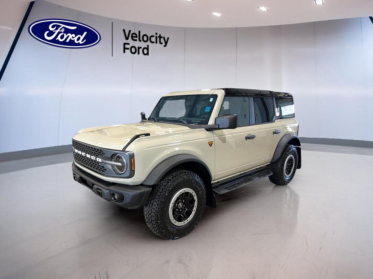 Built for real adventure and ready for daily use, this brand new 2026 Ford Bronco Badlands 4 Door 4x4 brings rugged capability to Moose Jaw with a bold Desert Sand exterior and a clean Black interior. Its 2.7-litre unleaded engine, 7-speed manual transmission, four-door layout, and convertible design deliver open-air freedom with serious off-road confidence.

FEATURES OF THE Bronco Badlands 4 Door 4x4
»» Removable roof adds open-air driving fun
»» Four-door body improves passenger access
»» Manual gearbox adds direct driver control
»» Off-road tires support trail-ready traction

ADVANCED SAFETY FEATURES
»» Anti-lock braking helps maintain steering control
»» Stability control supports confident road handling
»» Backup camera helps with reversing visibility
»» Blind spot monitor adds lane-change awareness

PERFORMANCE AND EFFICIENCY
»» 2.7-litre engine delivers strong usable power
»» Seven-speed manual adds engaging shifting feel
»» Four-wheel drive supports rough terrain travel
»» Limited slip differential improves traction grip

COMFORT AND CONVENIENCE
»» Heated front seats add cold-weather comfort
»» Dual-zone climate control helps cabin comfort
»» Cruise control supports relaxed highway driving
»» Power windows add everyday ease

TECHNONOLGY AND CONNECTIVITY
»» Bluetooth integration supports hands-free phone use
»» Navigation system helps guide every trip
»» WiFi hotspot keeps devices better connected
»» Steering wheel audio controls add convenience

CARGO SPACE
»» Rear trunk access simplifies loading gear
»» Four-door design helps passenger cargo flexibility
»» Spare tire adds roadside peace of mind
»» Versatile cabin suits daily gear needs

WHAT OTHER OWNERS LIKE
»» Open-air design makes drives more enjoyable
»» Strong off-road ability inspires driver confidence
»» Manual transmission feels engaging and fun
»» Practical four-door layout suits active lifestyles

This 2026 Ford Bronco Badlands 4 Door 4x4 is a purpose-built SUV that blends classic utility with modern features drivers want every day. At Velocity Ford, this new Bronco stands out for buyers who want capable four-wheel drive performance, easy-to-use technology, and true outdoor versatility without giving up comfort.

The Desert Sand finish gives this 2026 Ford Bronco Badlands 4 Door 4x4 a rugged, ready-for-anything look that suits back roads, trails, and city streets alike. Heated mirrors, electric mirrors, tinted windows, fog lights, LED headlamps, and automatic headlights help support visibility and convenience in changing Prairie conditions.

Inside, this 2026 Ford Bronco Badlands 4 Door 4x4 keeps things practical and driver-focused. You get front air conditioning, automatic climate control, push button start, an adjustable steering wheel, a leather steering wheel, ambient lighting, and illuminated vanity mirrors for both front occupants. The layout is simple, useful, and ready for everyday driving.

Safety and driver support are well covered in this 2026 Ford Bronco Badlands 4 Door 4x4. It includes driver and passenger airbags, side impact airbags, head side airbags, a passenger airbag sensor, child safety locks, lane departure warning, tire pressure monitoring, and automatic door locks. These features help support peace of mind on every trip.

This 2026 Ford Bronco Badlands 4 Door 4x4s VIN is: 1FMEE9BP7TLA75640.
